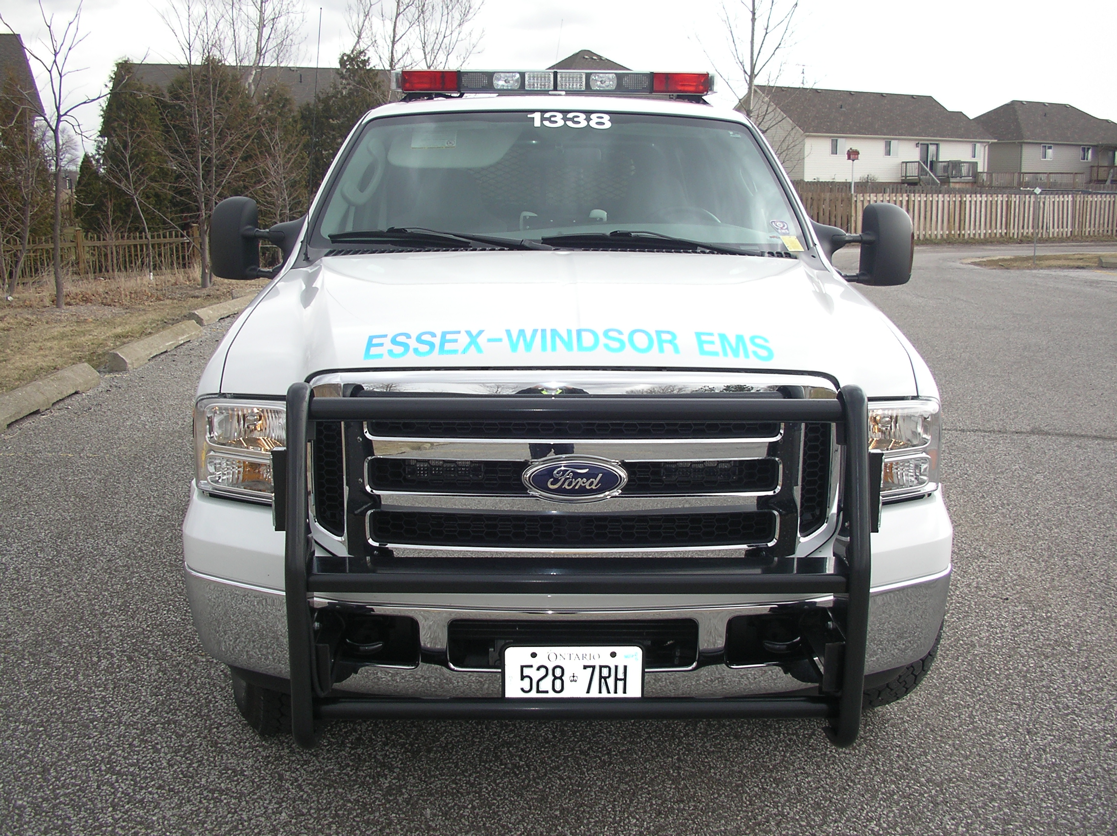 Four Essex-Windsor EMS Paramedics with vials of COVID-19 vaccine