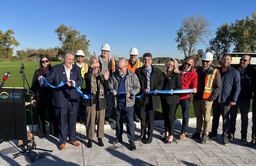 Warden Hilda MacDonald cuts a blue ribbon with colleagues at the roundabout at County Road 42 and County Road 43