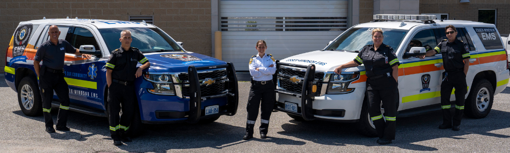 Members of the Essex-Windsor EMS Mobile Integrated Healthcare Community Paramedicine team with two of their vehicles.