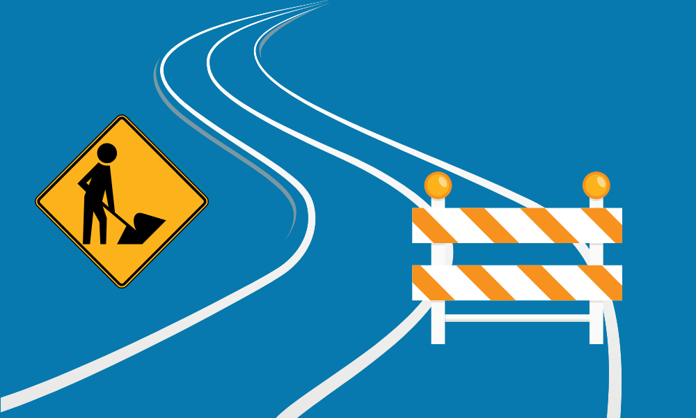Construction icons and the outline of a curving road against a blue background