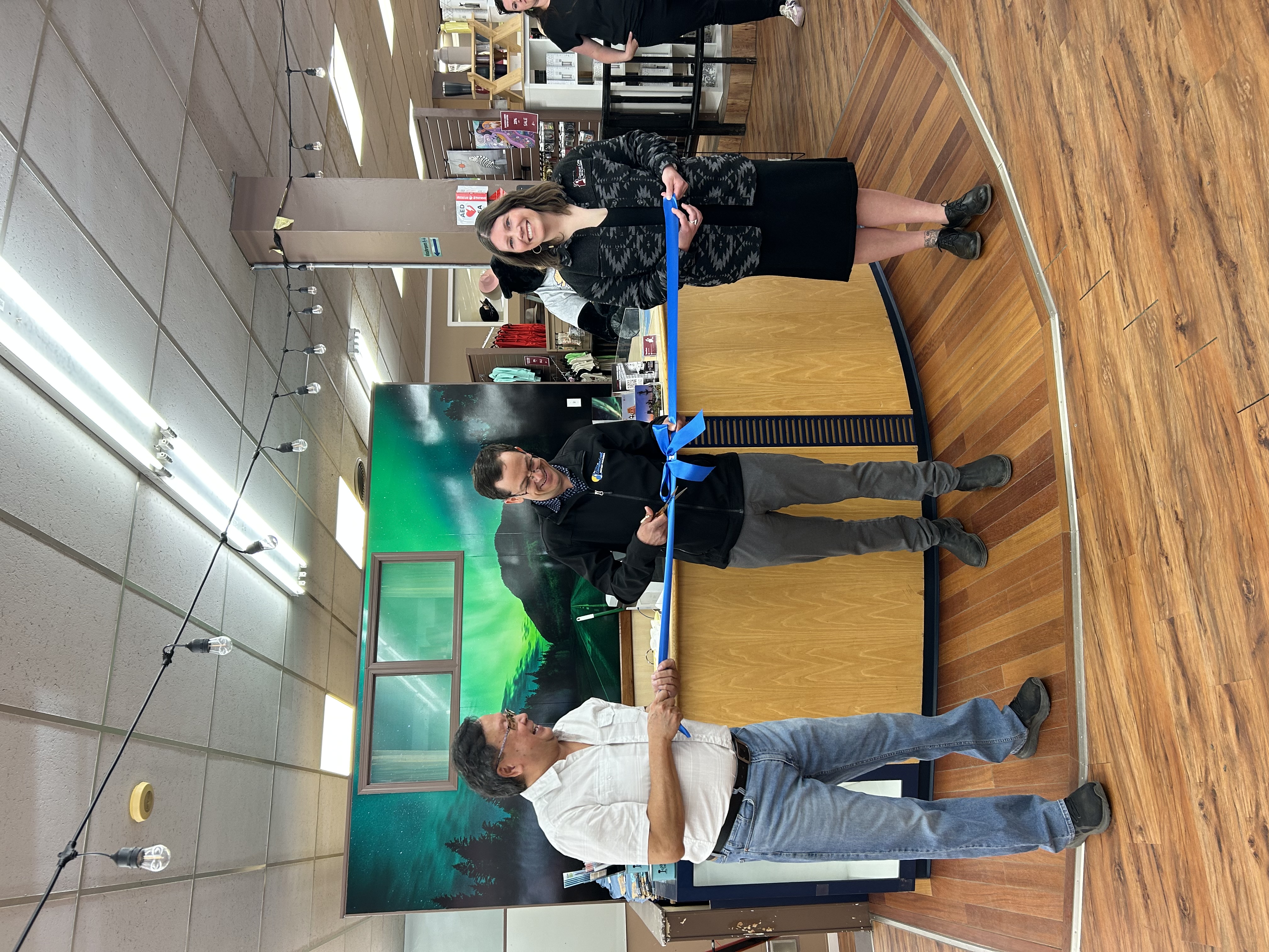 A photo of Ed Mah, Mayor Darcy Dober and Chelsea Mottishaw Tourism Manager cutting a blue ribbon