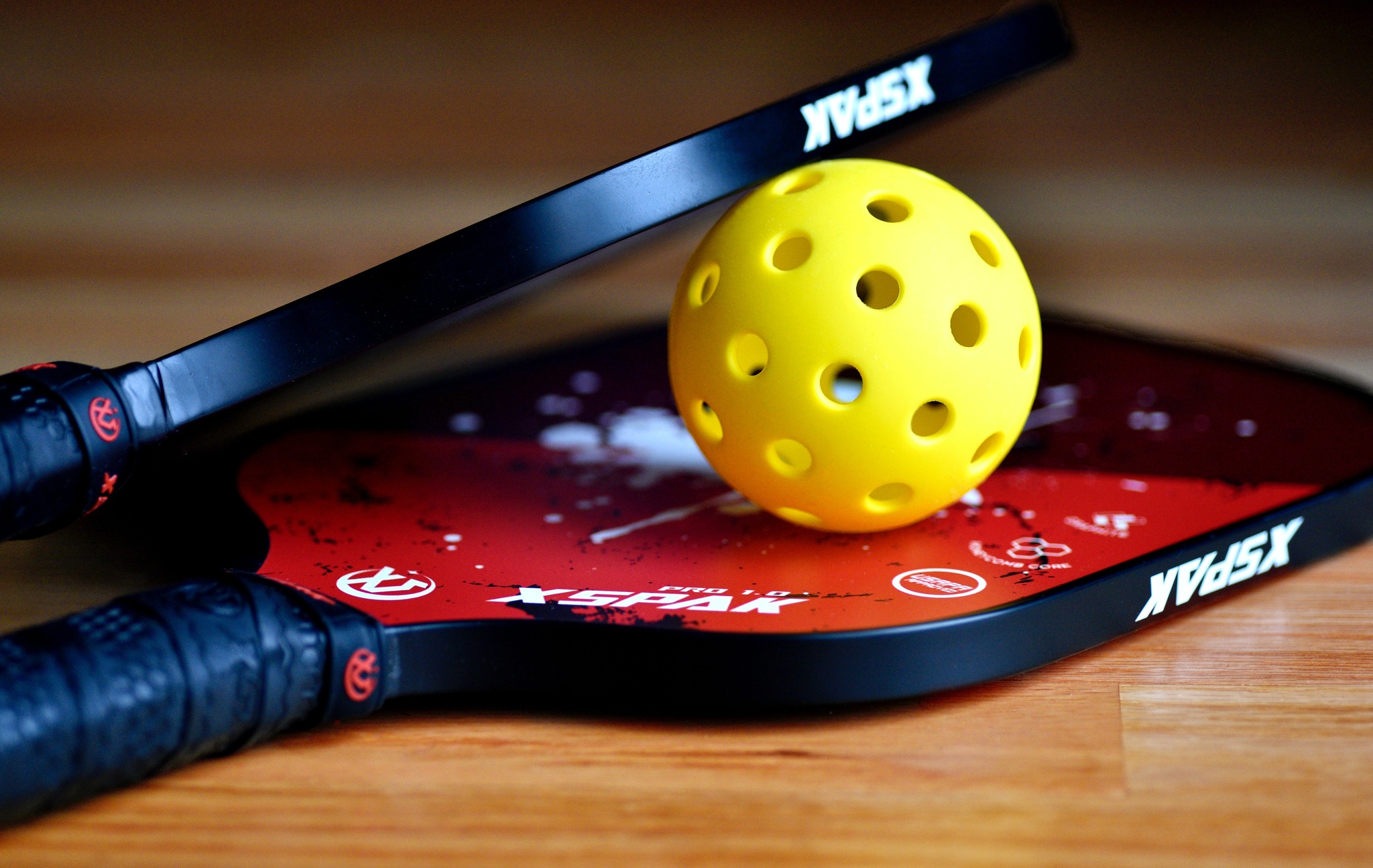 a pickleball ball and racket