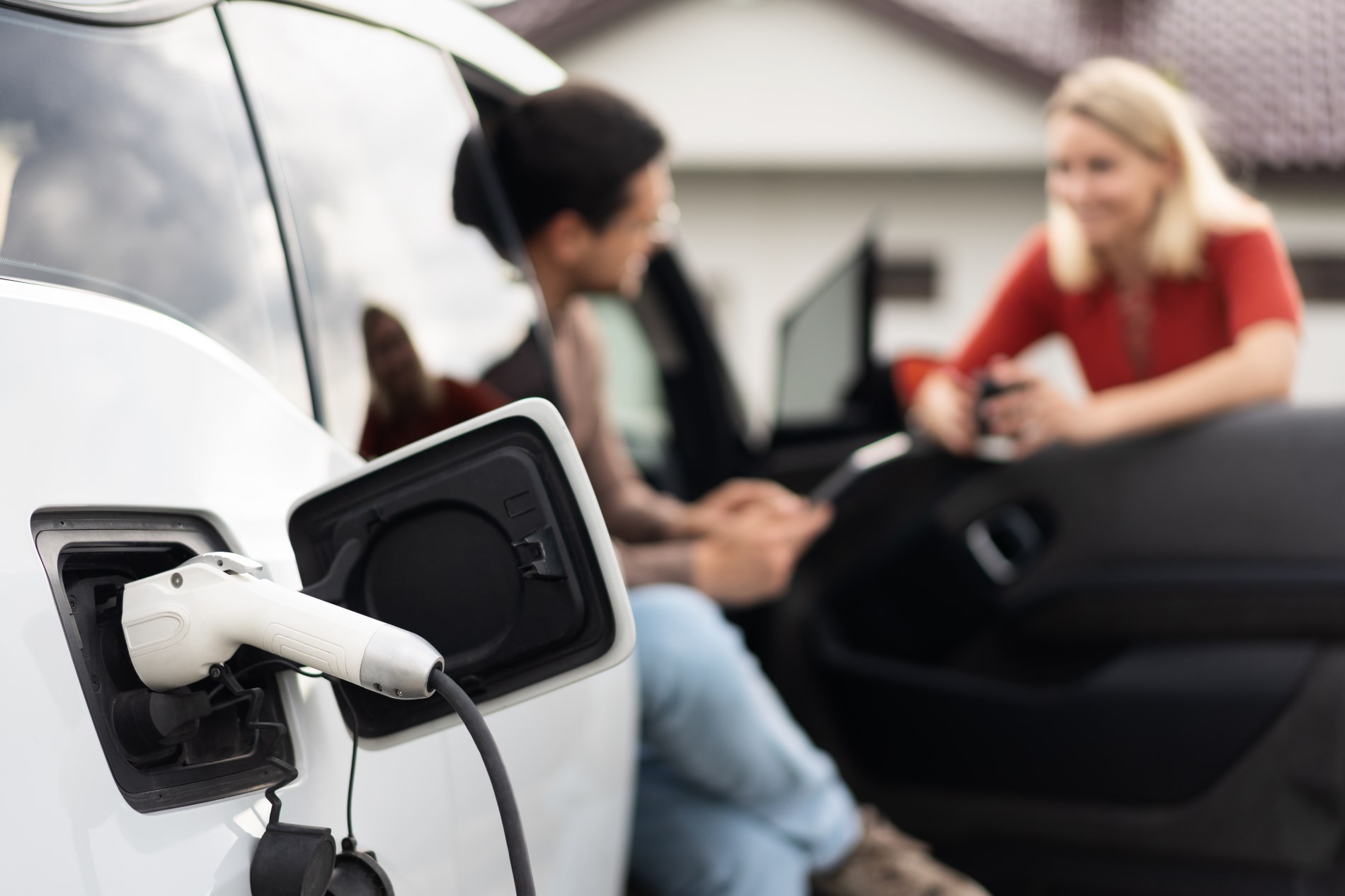 People chatting near an EV Charger