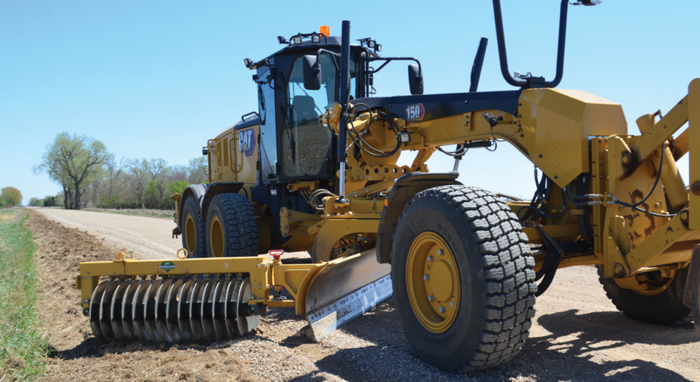 a gravel retrieval attachment on a raod grader