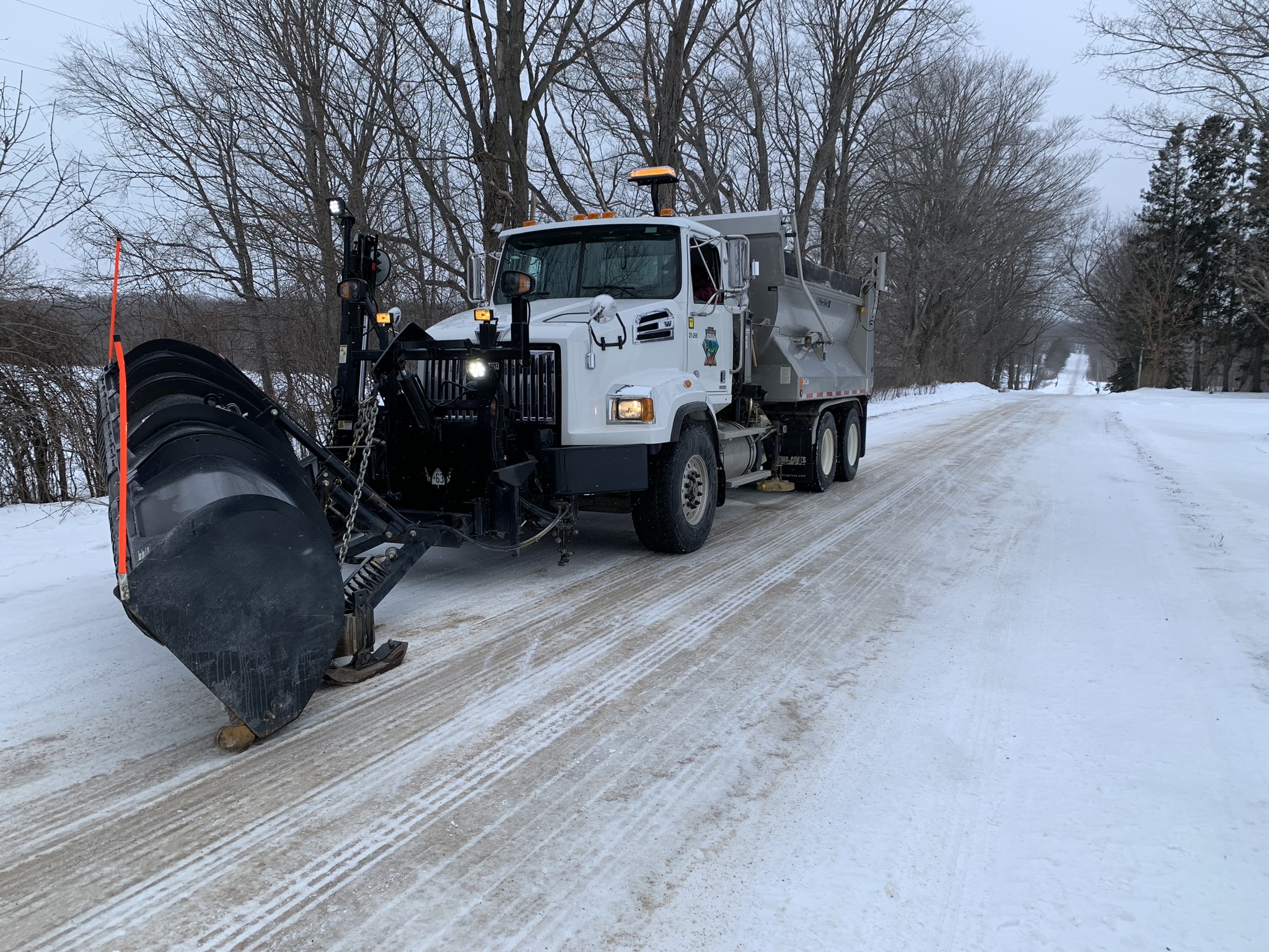 A plow truck on a snowy road