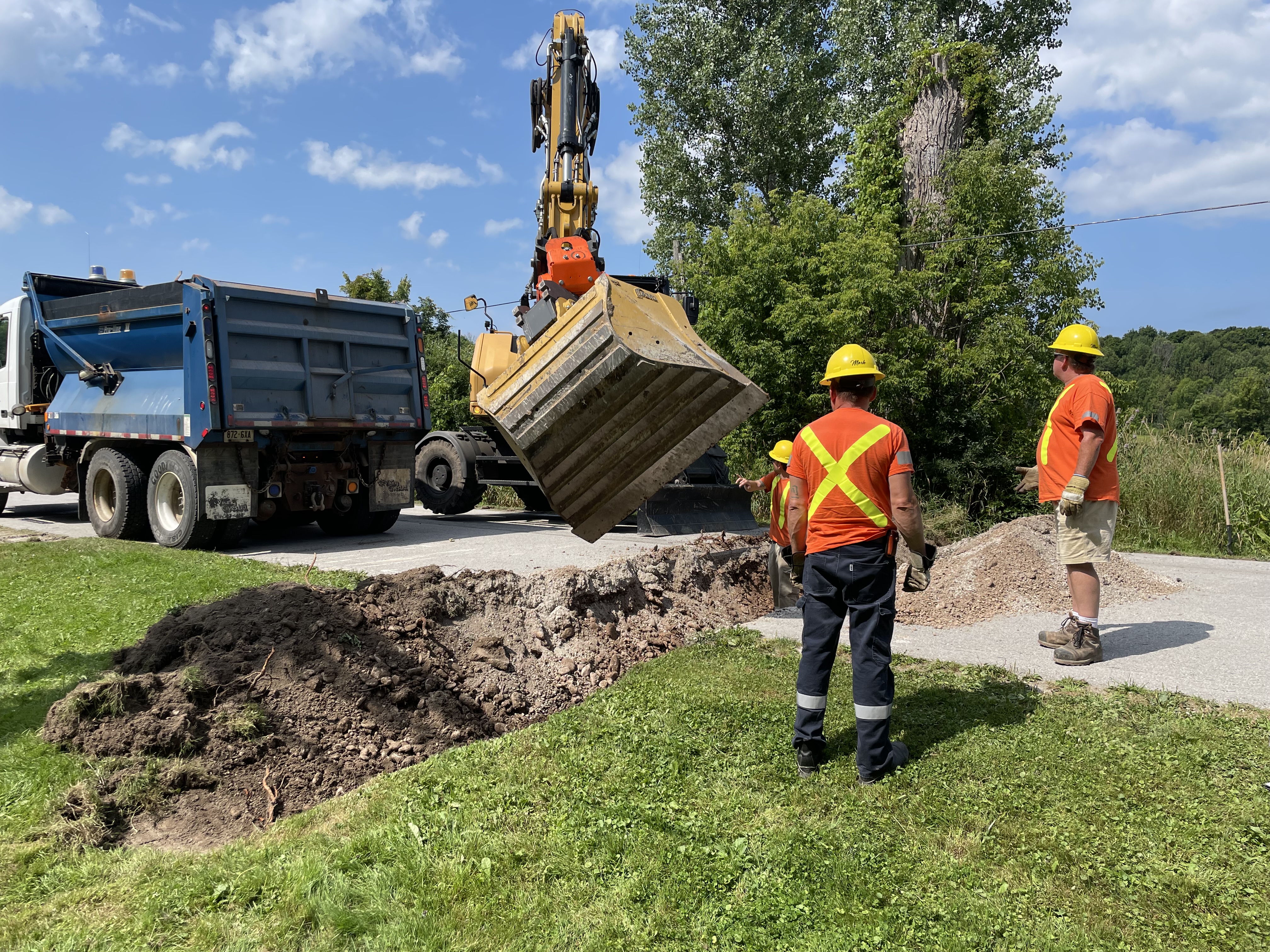 a road crew digging a culvert