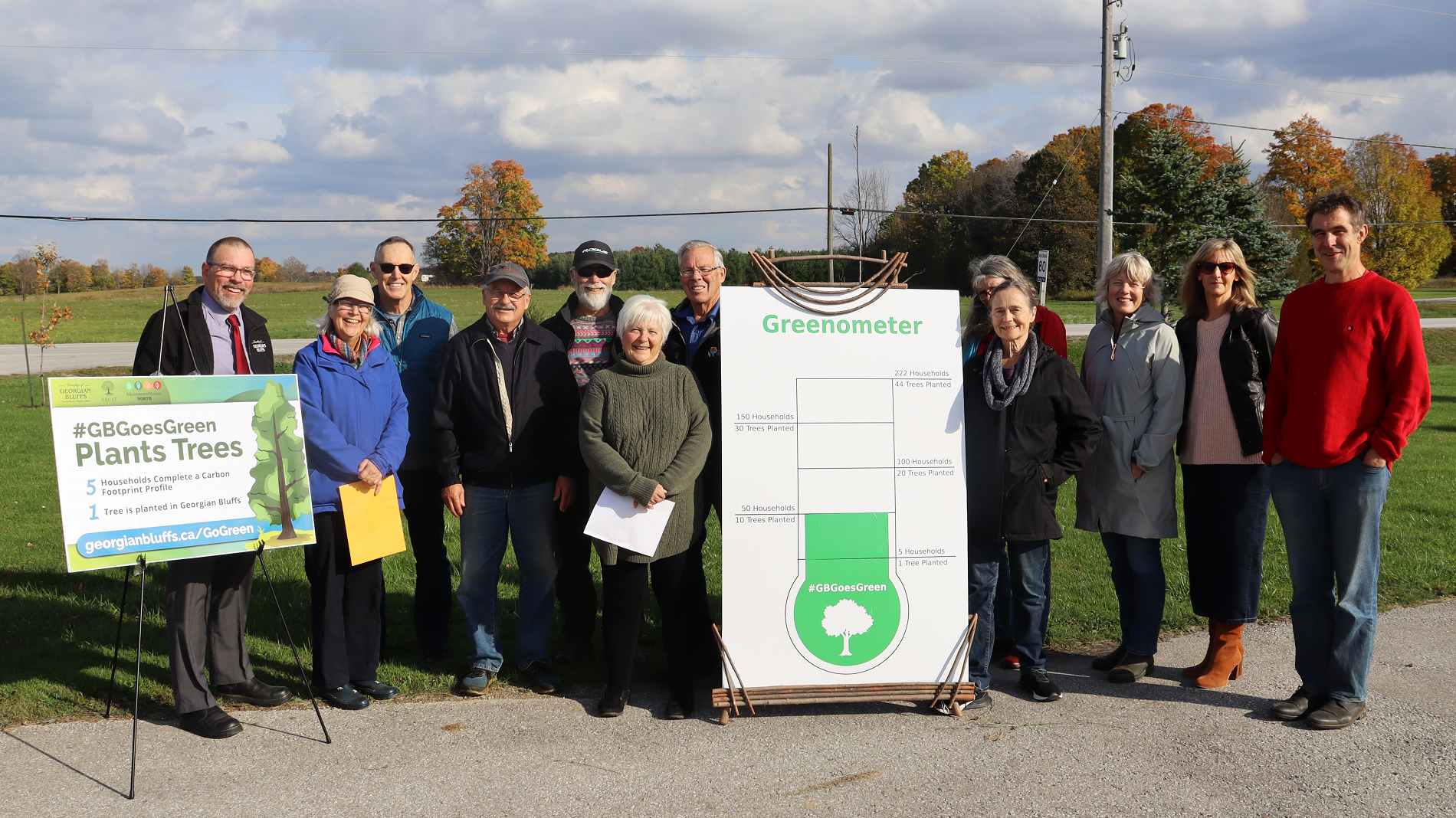 member of staff with greenometer sign
