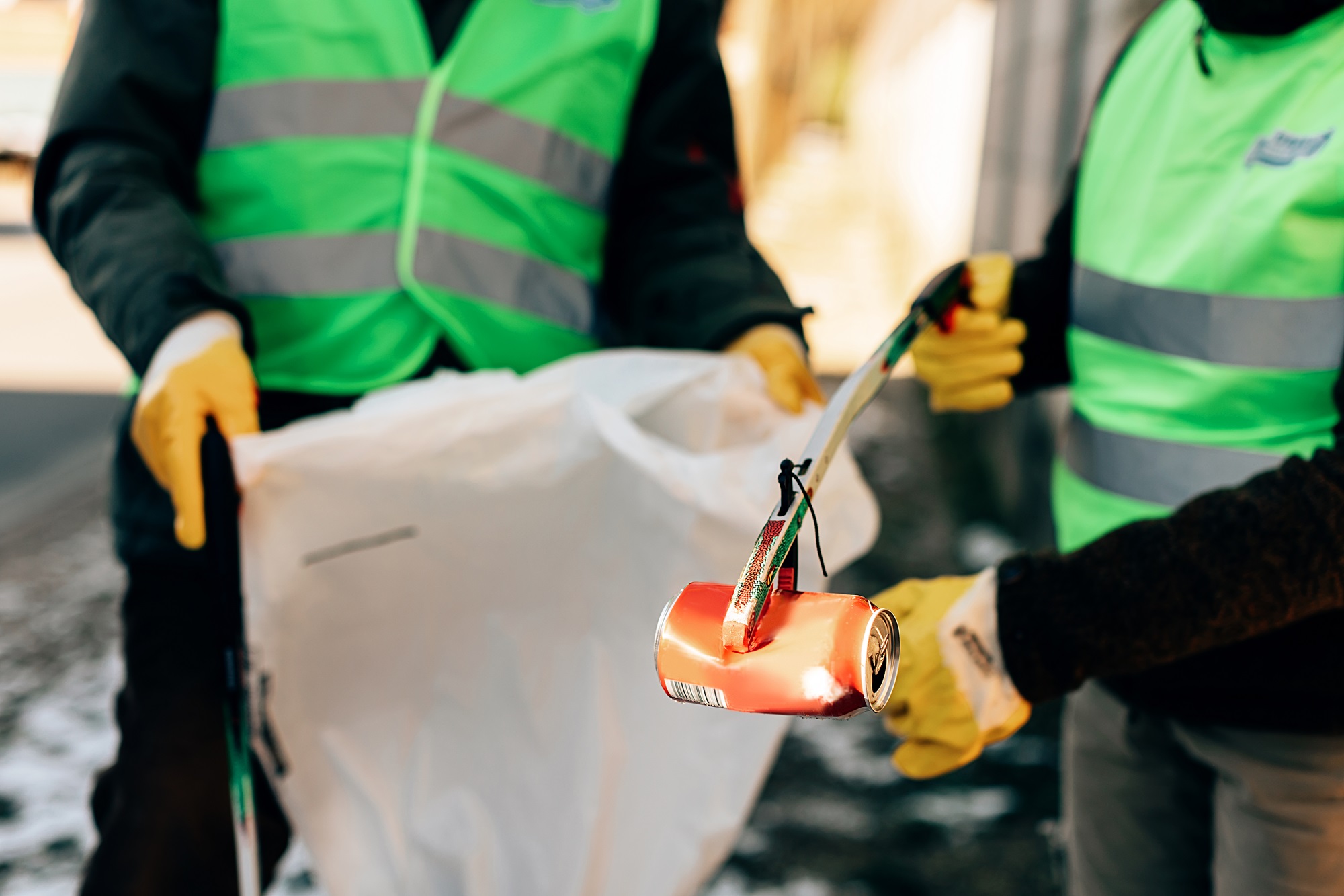people in PPE cleaning up litter