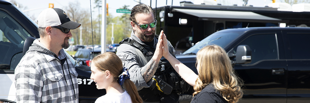 Officer giving a young girl a high-five