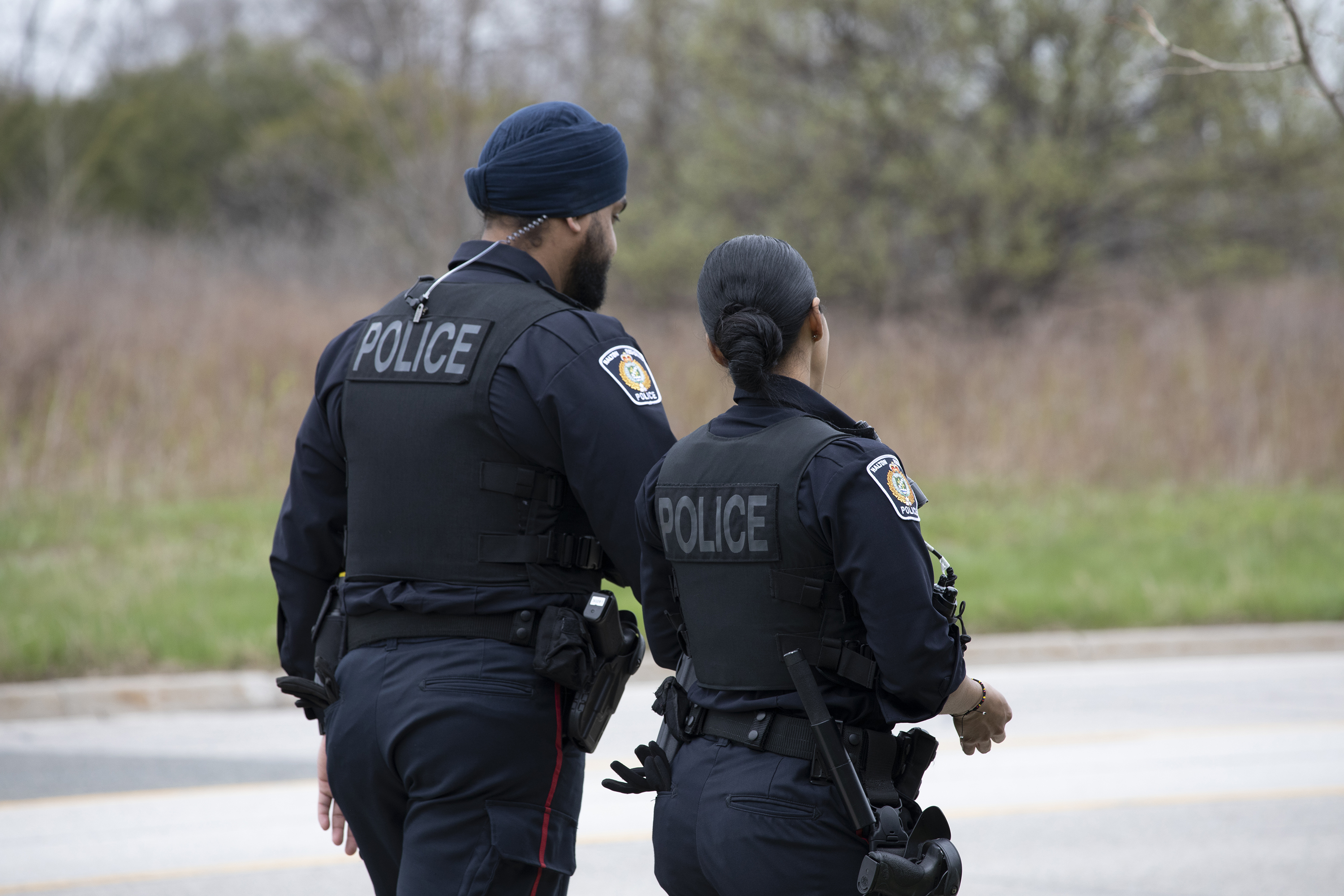 Backs of two officers walking and talking