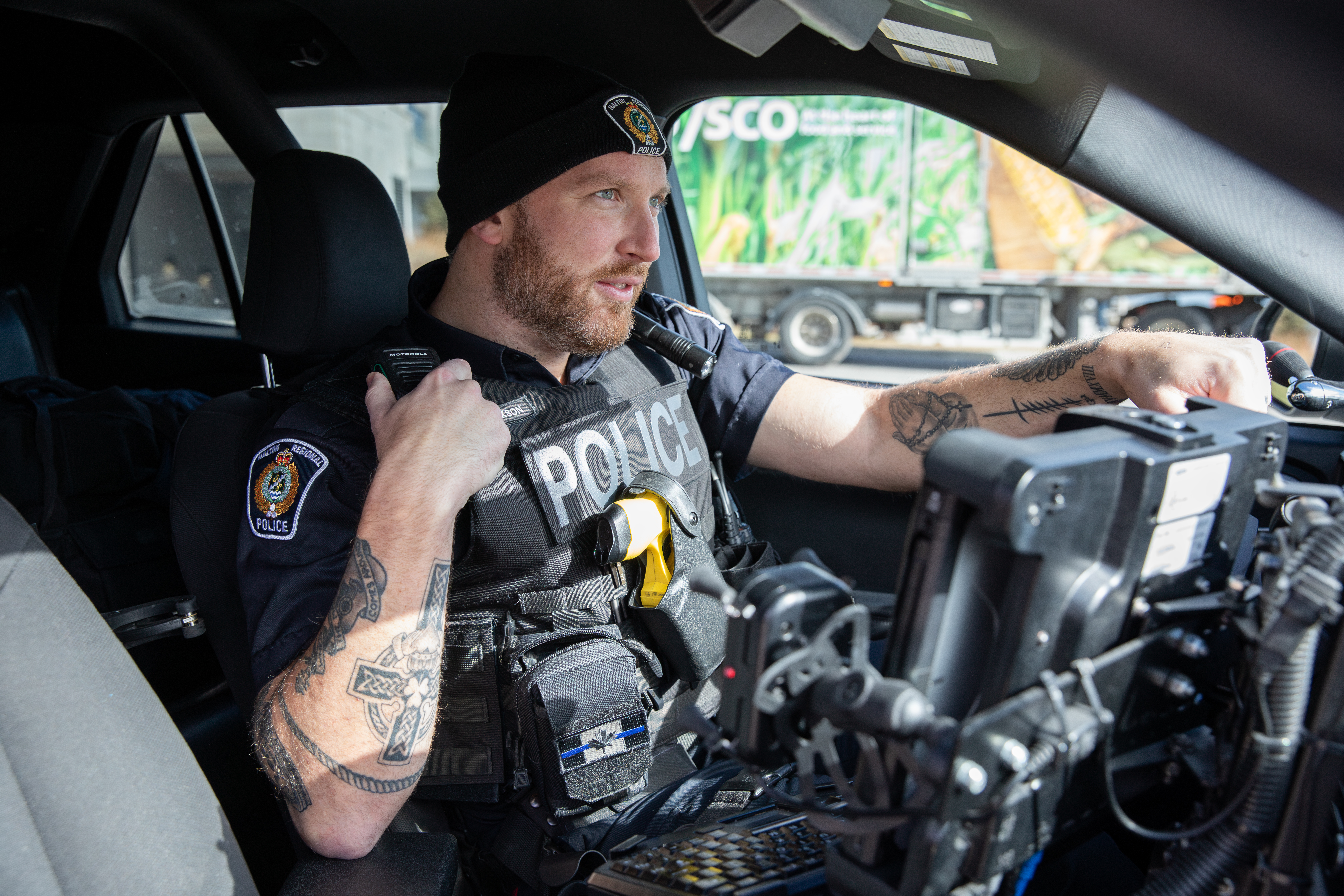 An officer in a cruiser, using the radio.