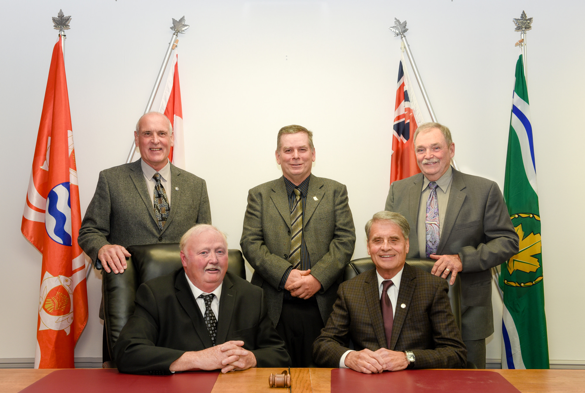 The mayor and council posing in Council Chambers