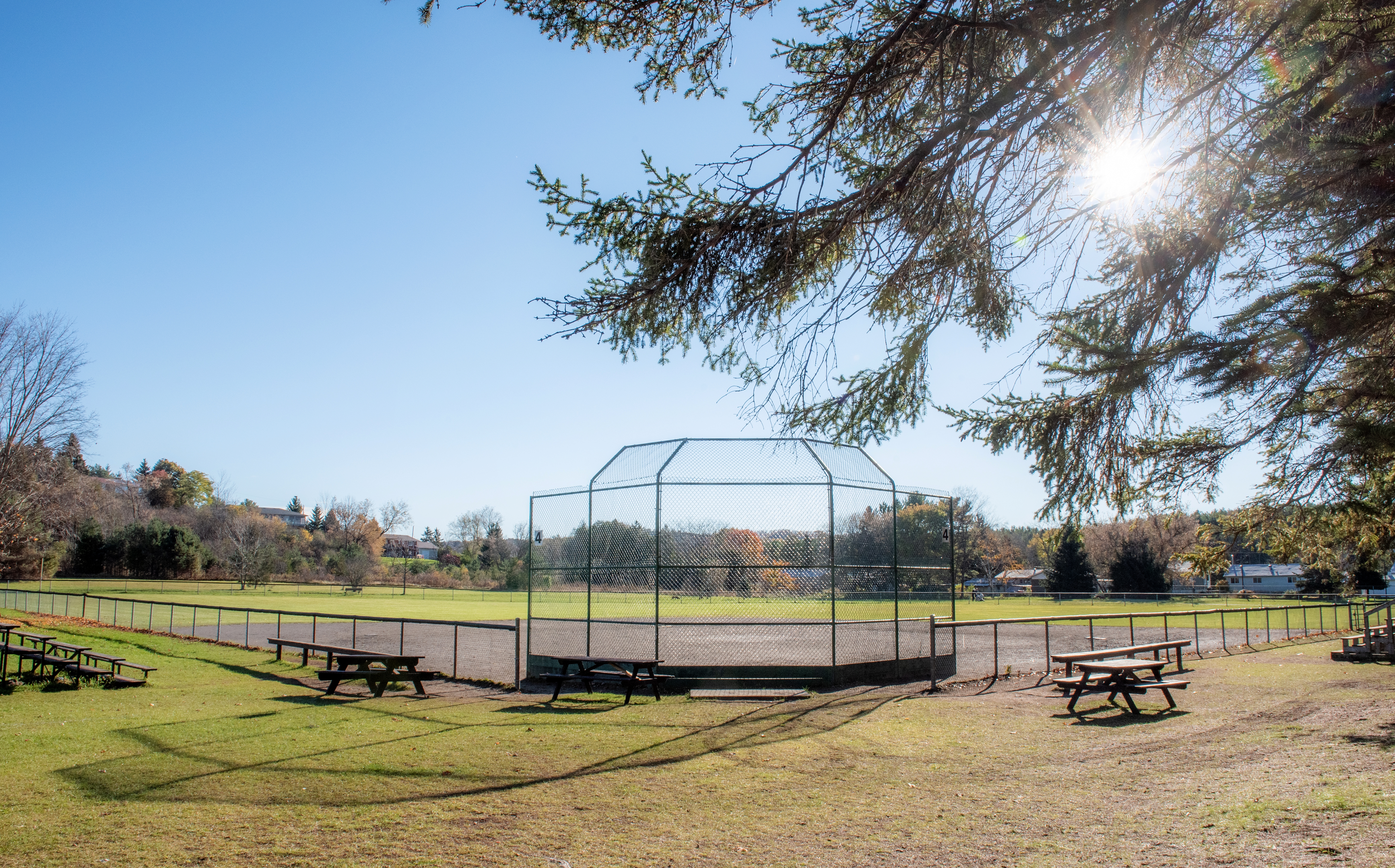 Baltimore Arena baseball diamond surrounded by picnic tables and bleachers