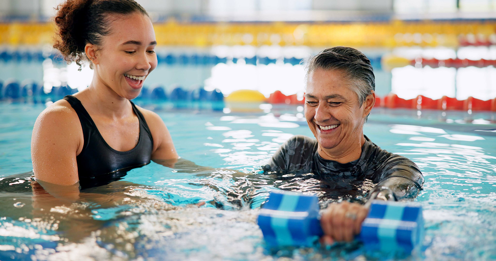Swim instructor with adult student