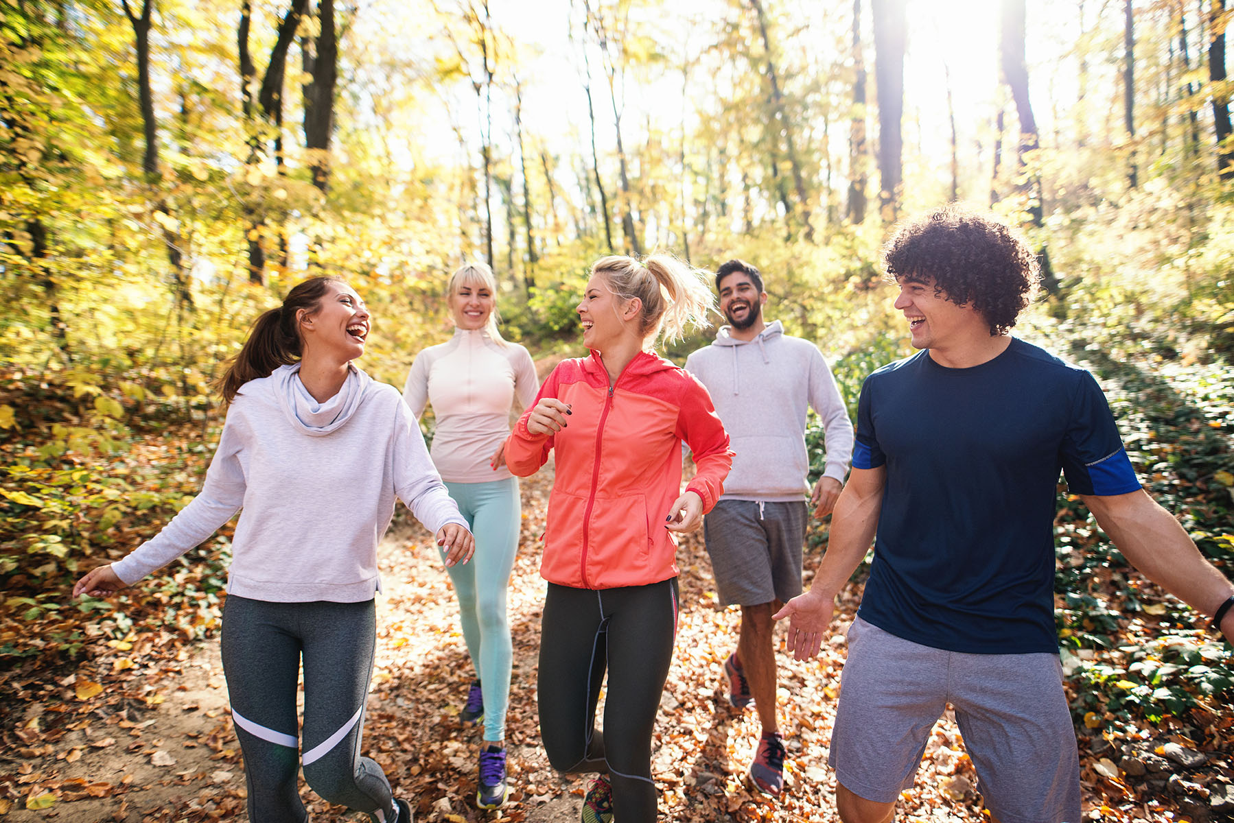 Active Group walking on fall trail