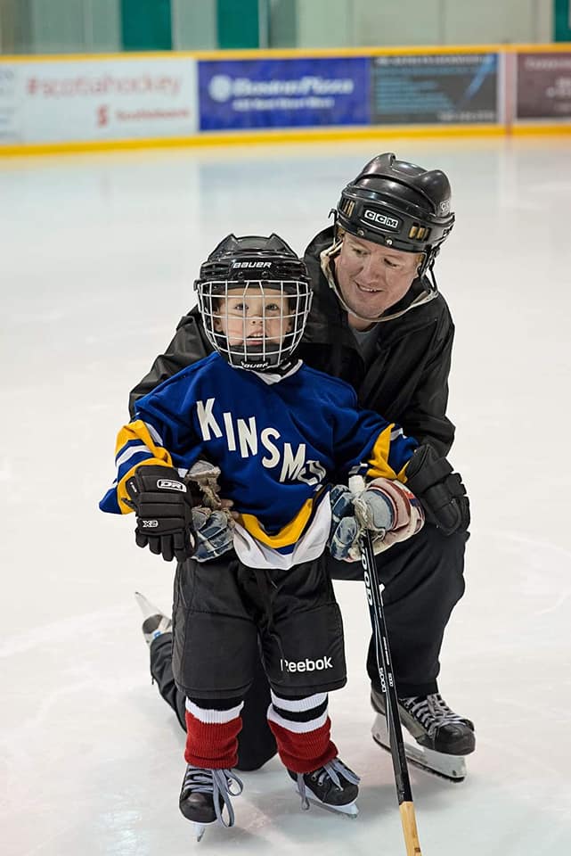 Father and Child enjoying Stick and Puck