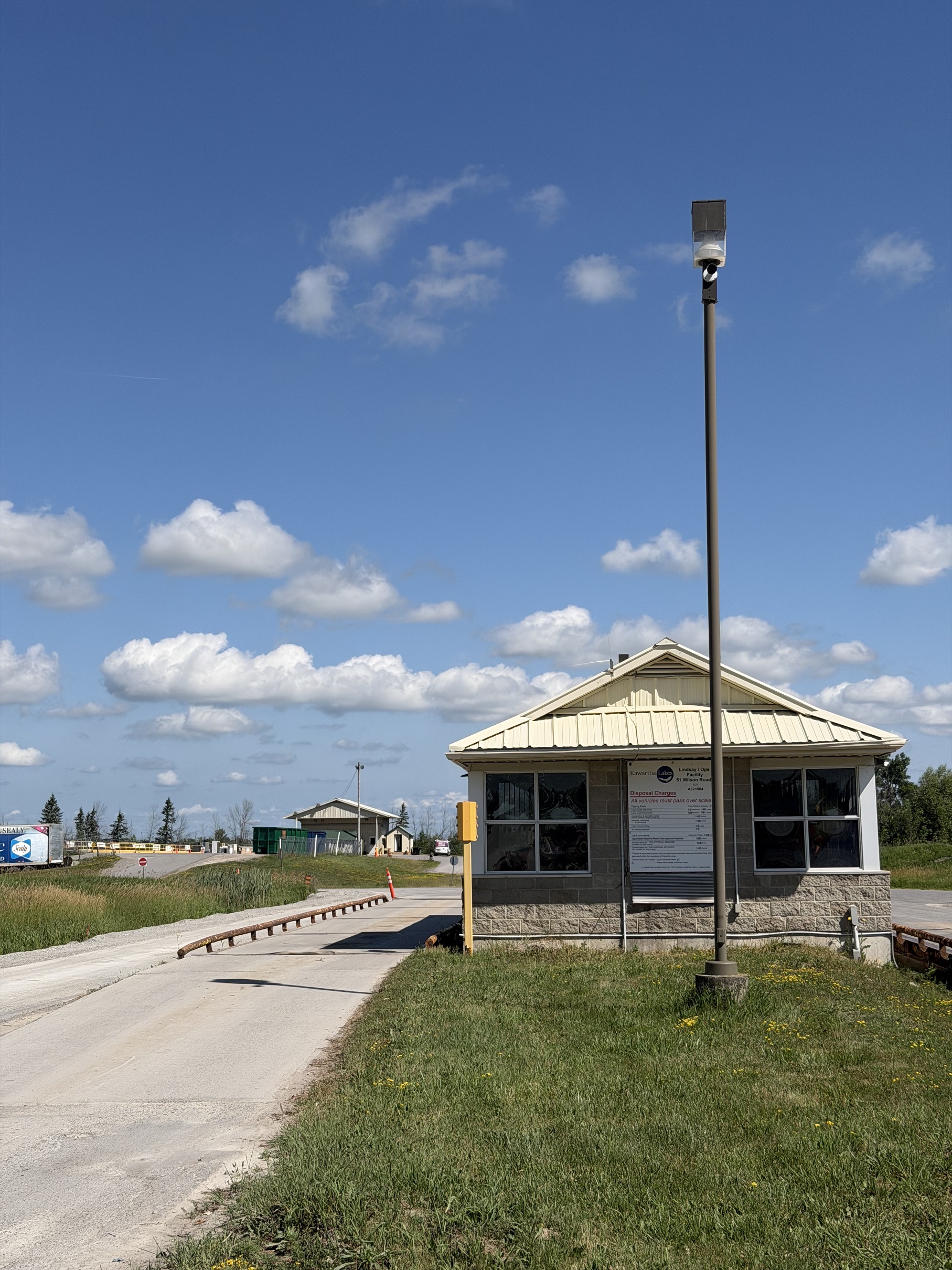 landfill building with a single lane to the left and the household hazardous waste building in the distance