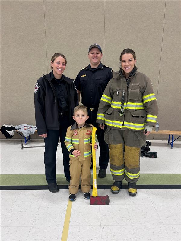 student standing in front of firemen