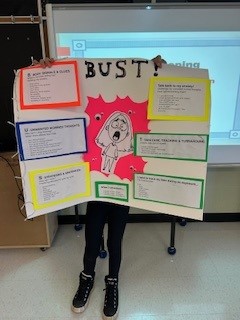 Student holding up a poster board 