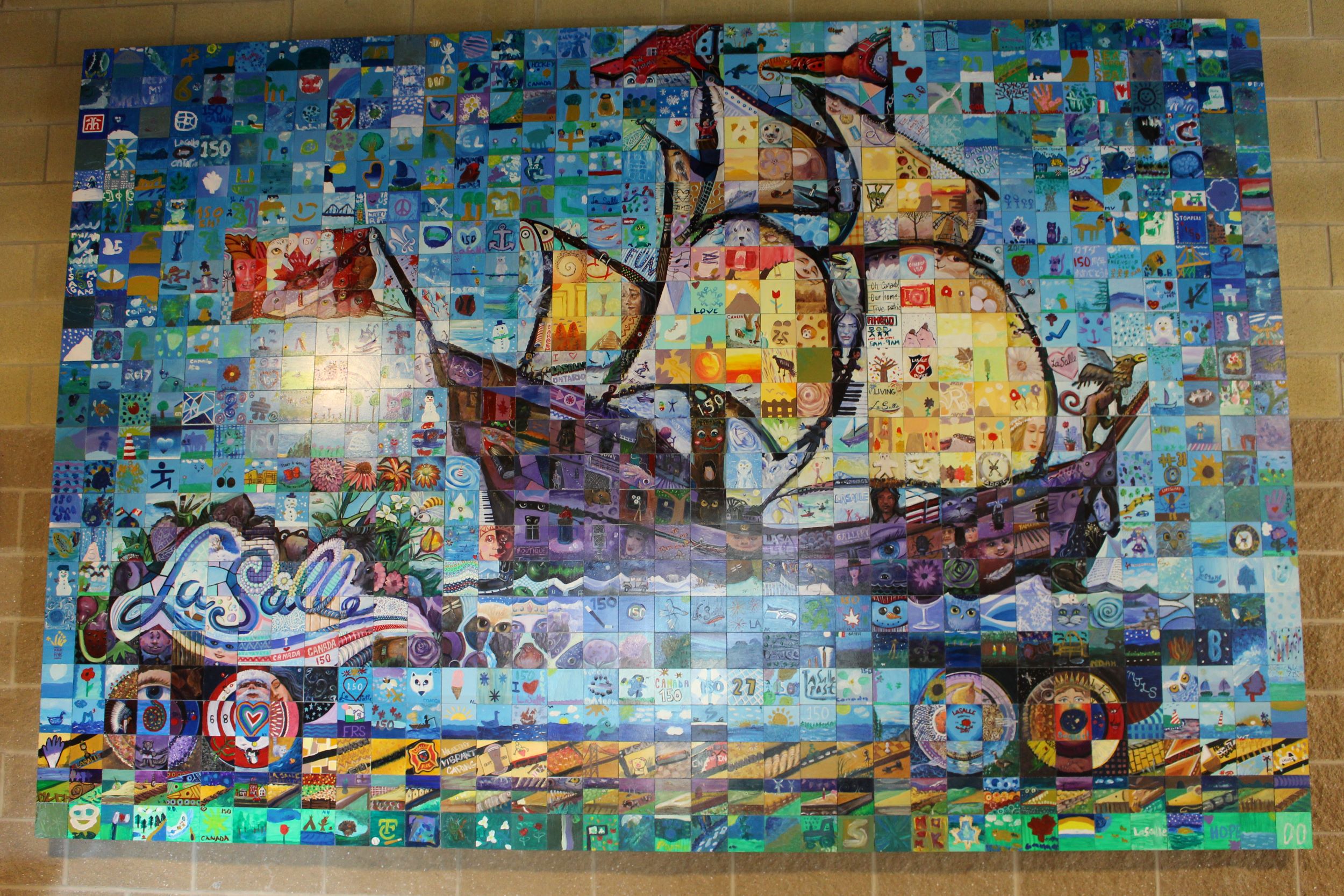 Photo of a mural created with individually painted squares depicting a ship on a train car.