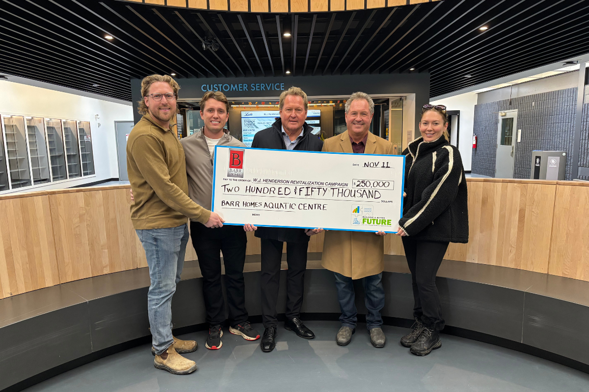 Barr Homes representatives holding a ceremonial cheque