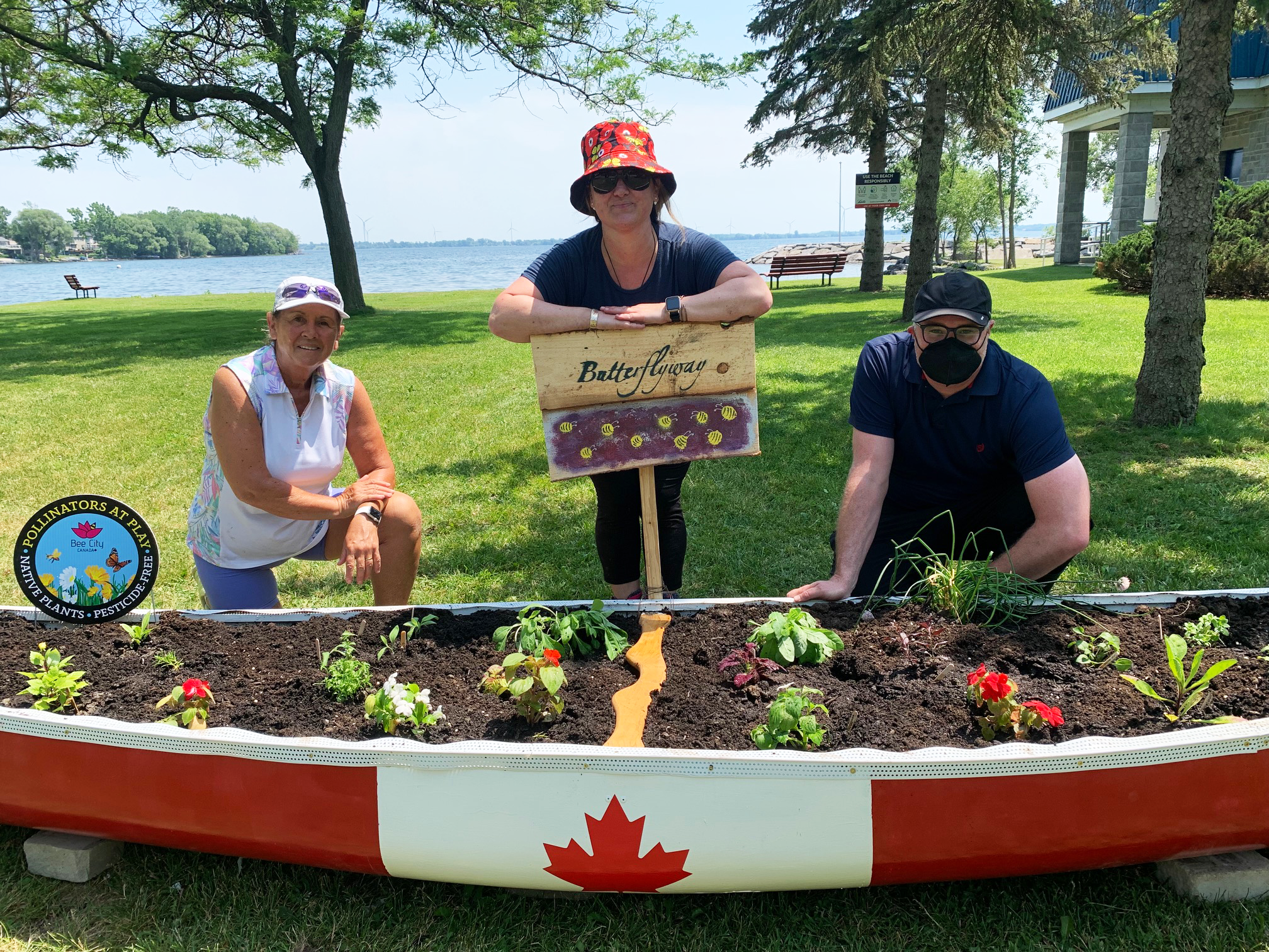 butterflyway pollinator garden in Bath Centennial Park, installed in a canoe painted with a Canadian flag