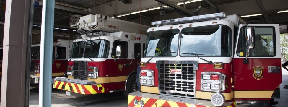 Fire trucks parked in a fire hall garage