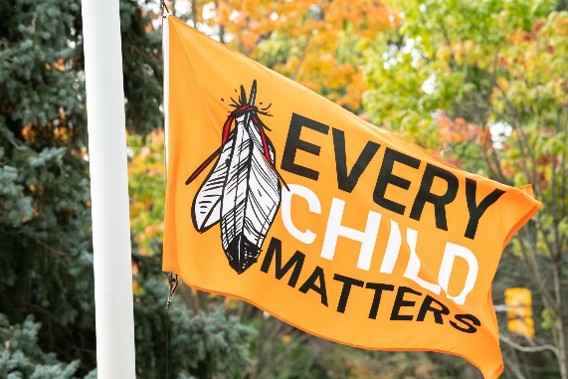 A waving orange flag reading Every Child Matter