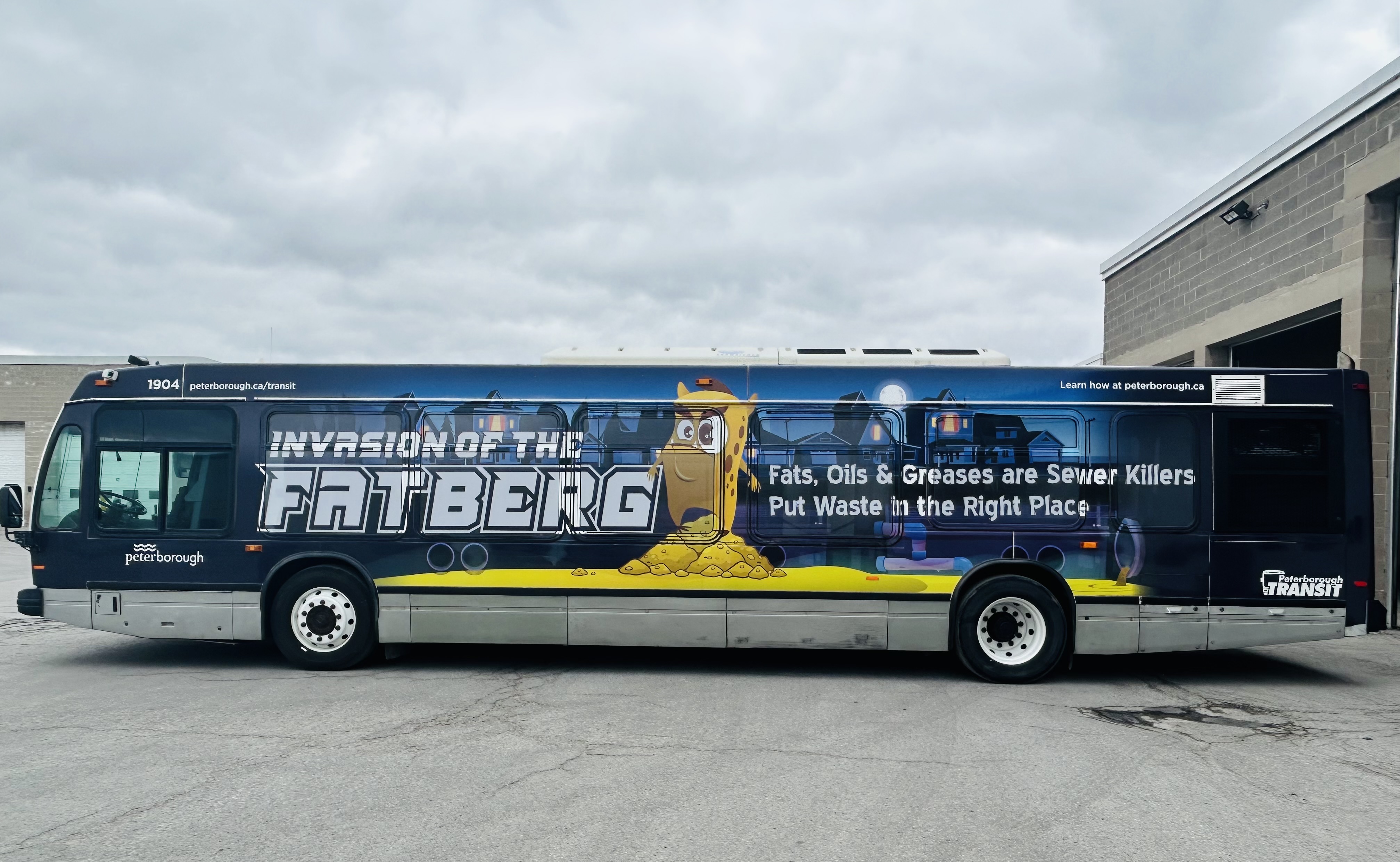 Photo of a City bus with a "Fatberg" waste management advertising wrap on it.