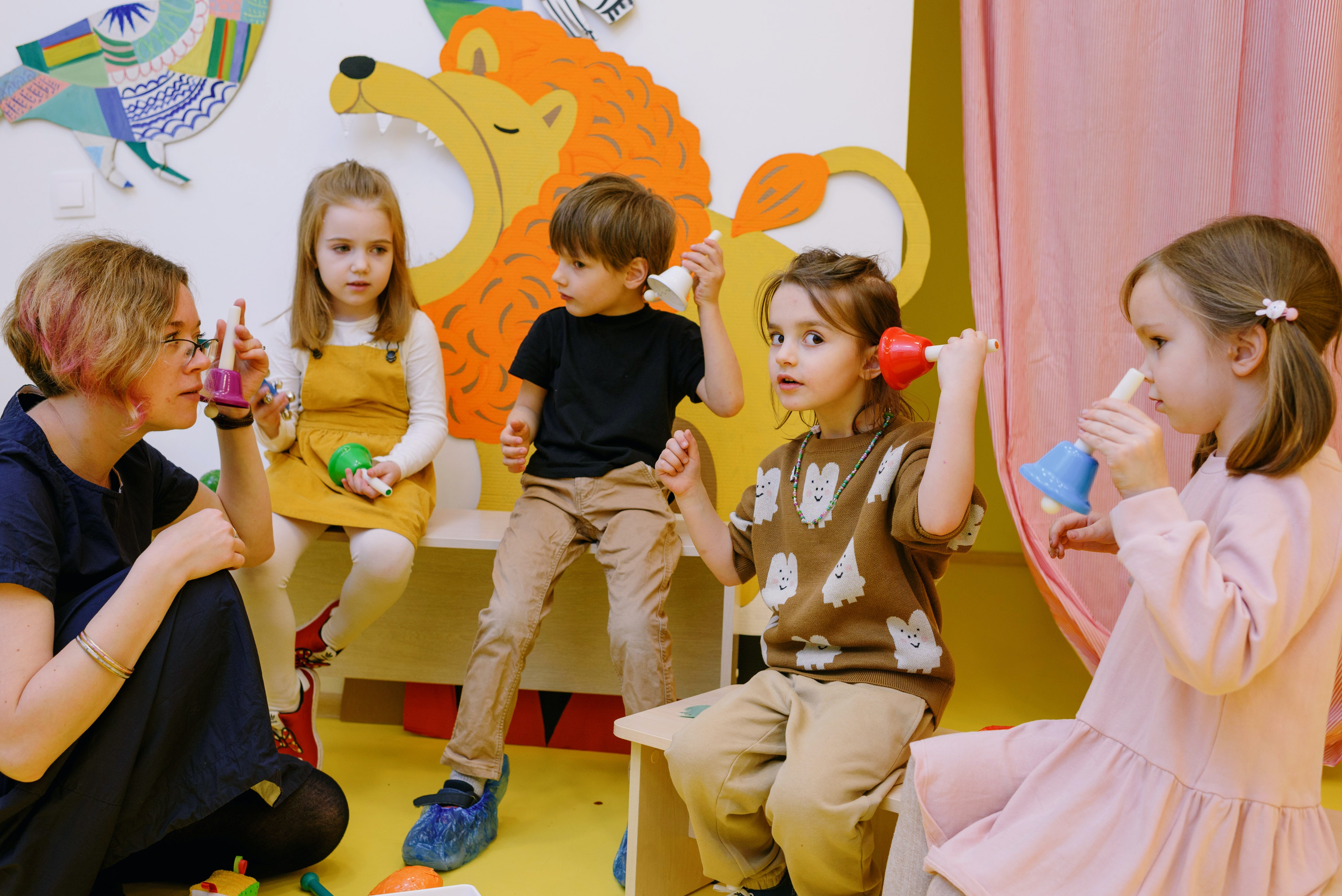 Early childhood educator works with a small group of young children