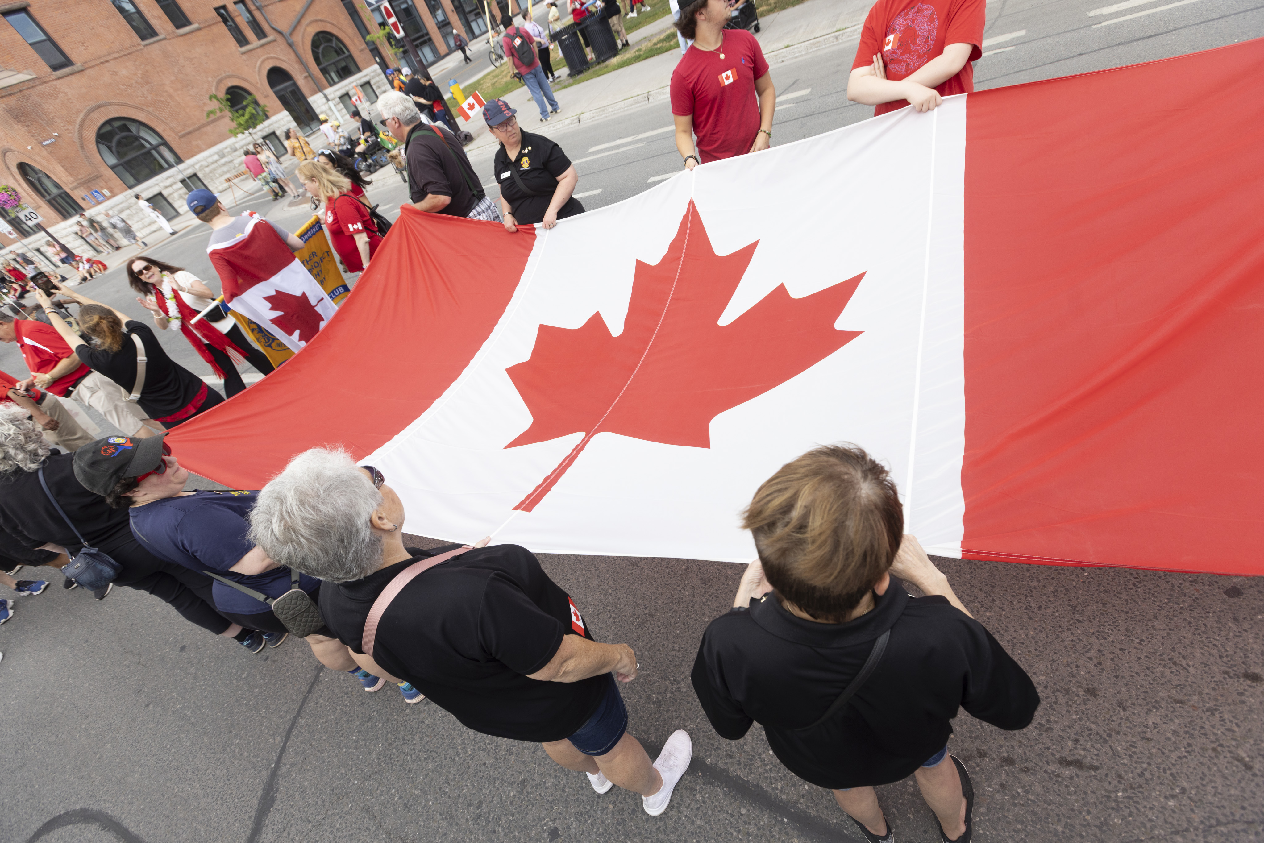 People holding Canada Day flag for Canada Day Parade