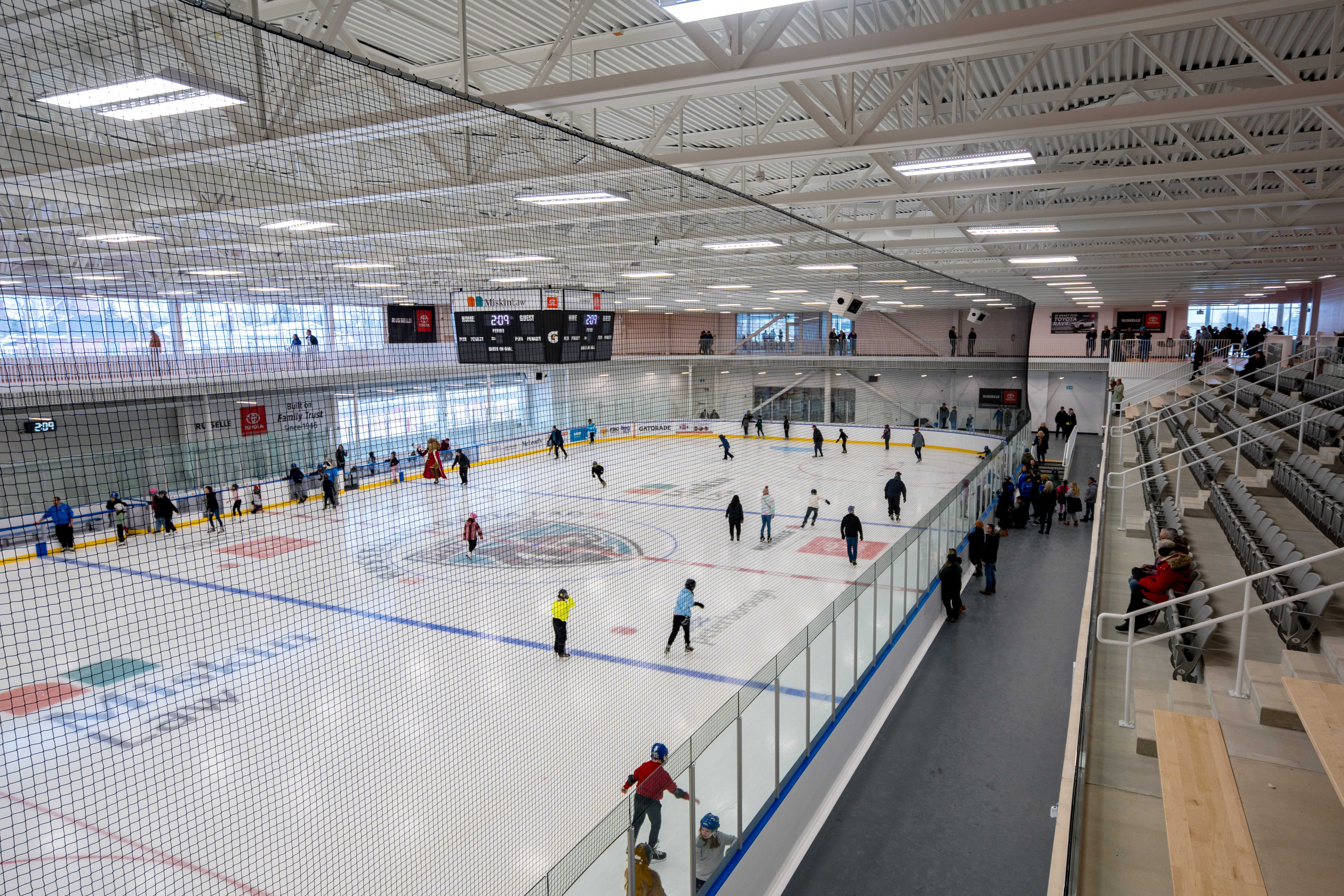 Aerial image showing dozens of skaters on one of the twin pads at the MIskin Law Community Complex.