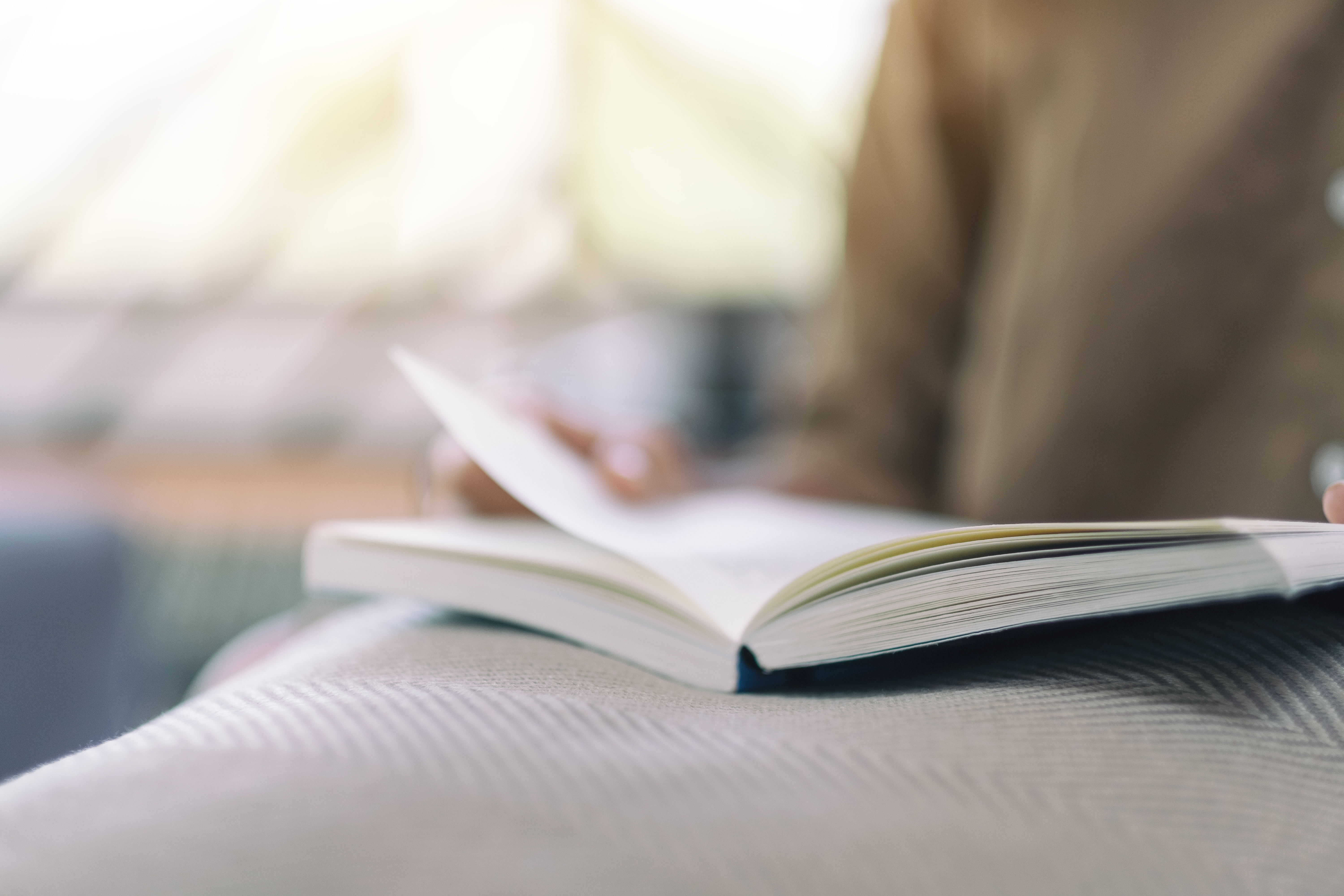 Closeup image of a woman opening and reading a book