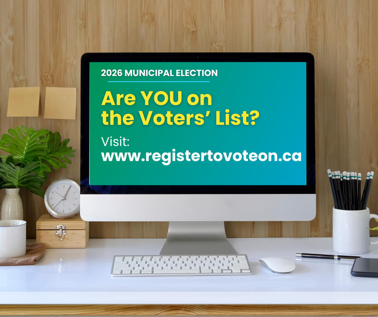 Photo of computer on desk with 'Are You on the Voters' List' on the screen