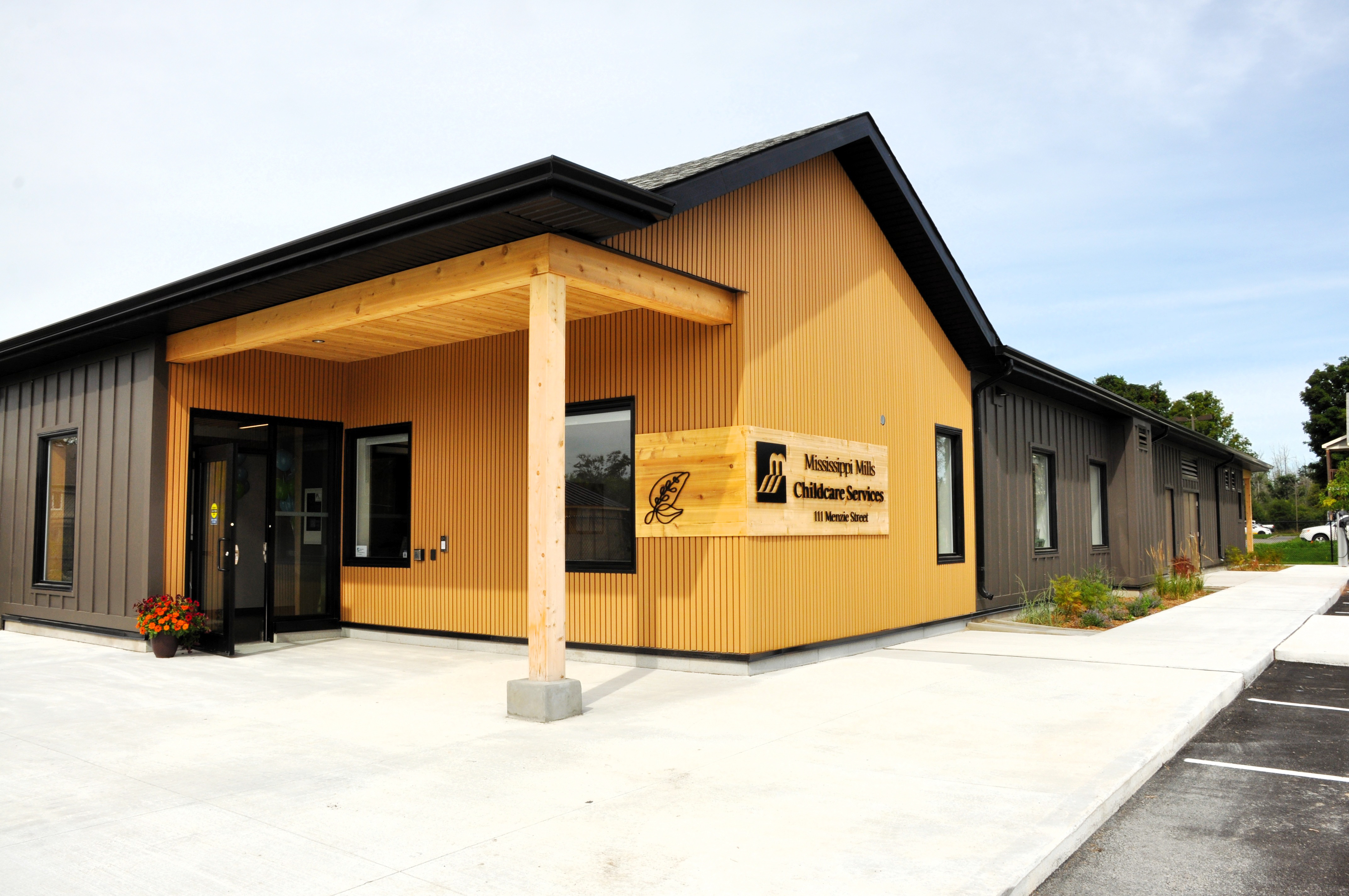 A one-storey building with wooden and steel features