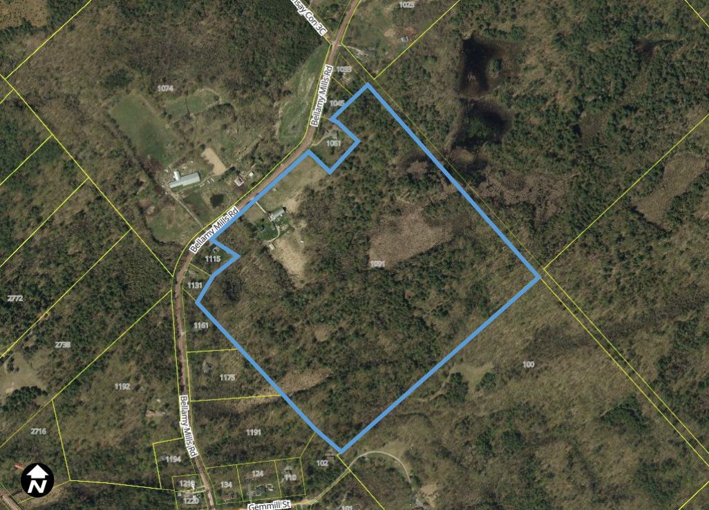 Satellite image of rural treed area with a blue box outlining a property