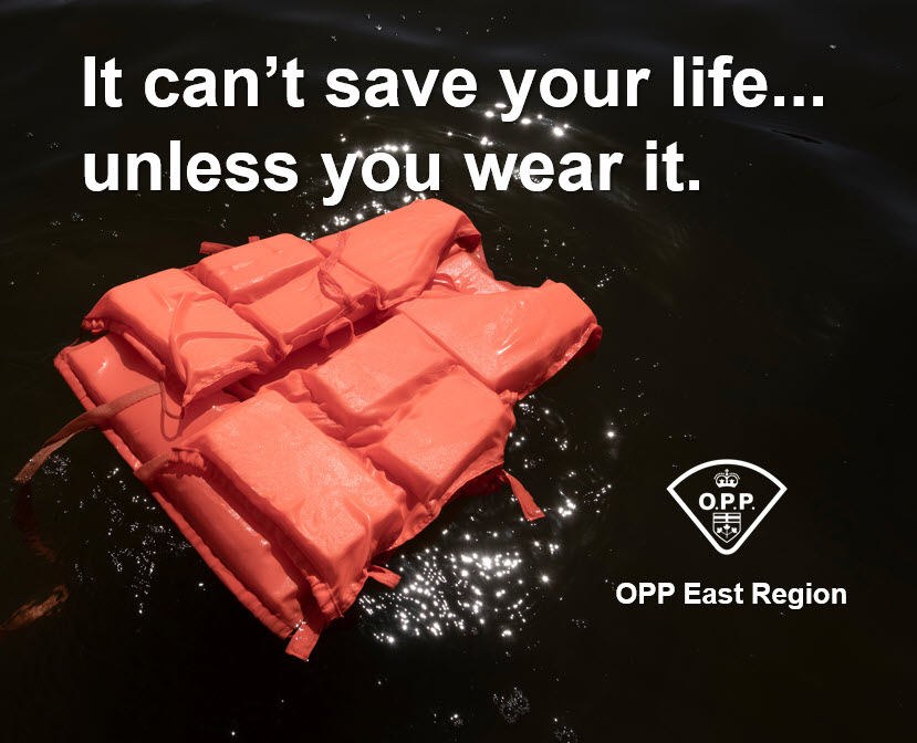 Photo of red lifejacket floating in dark water and the text 'It can't save your life unless you wear it'