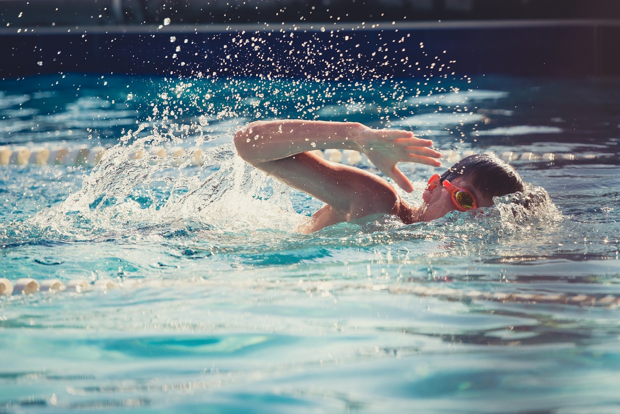 Kid swimming in outdoor pool