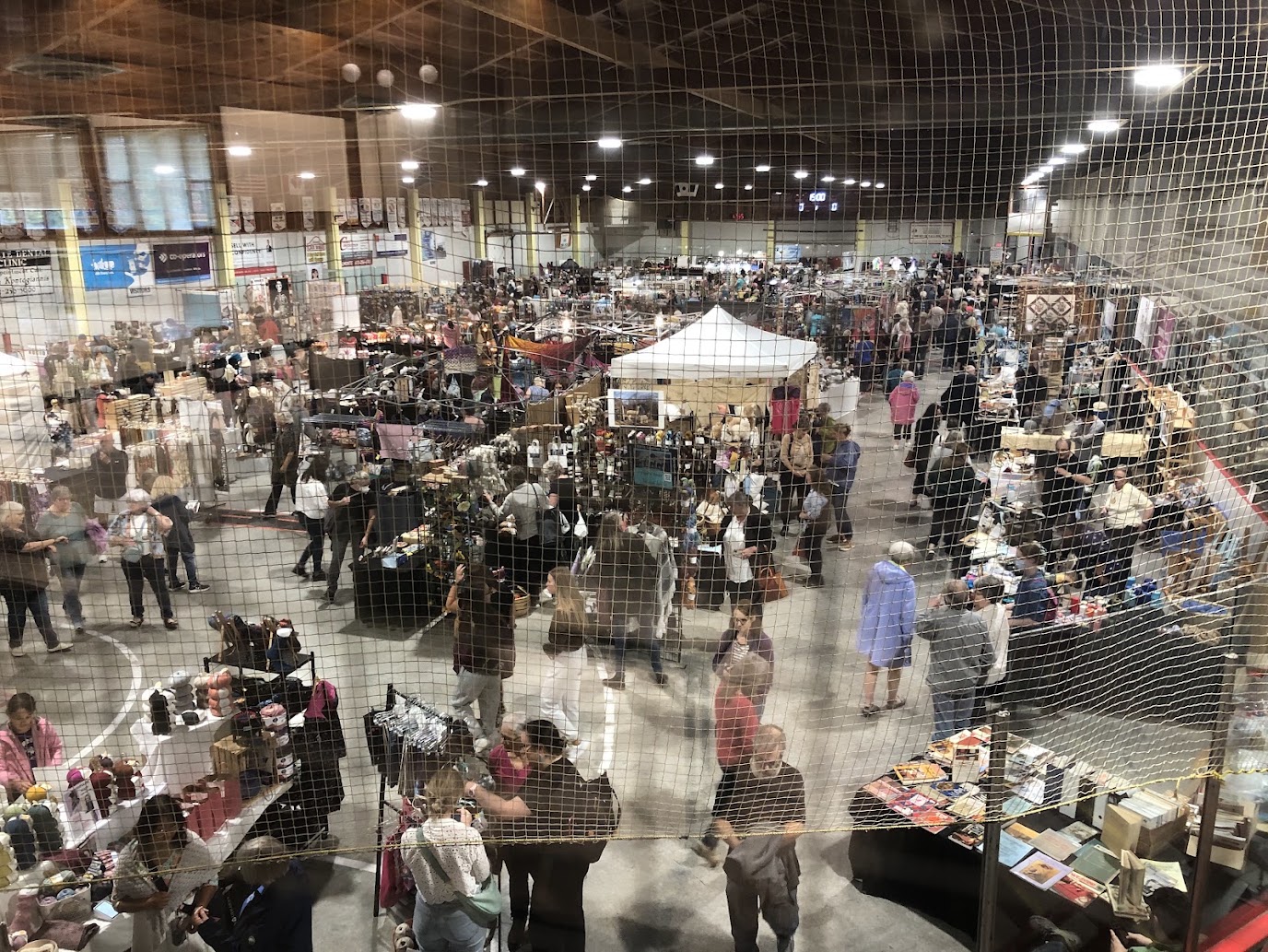 Aerial view of a craft show with vendors in a community centre