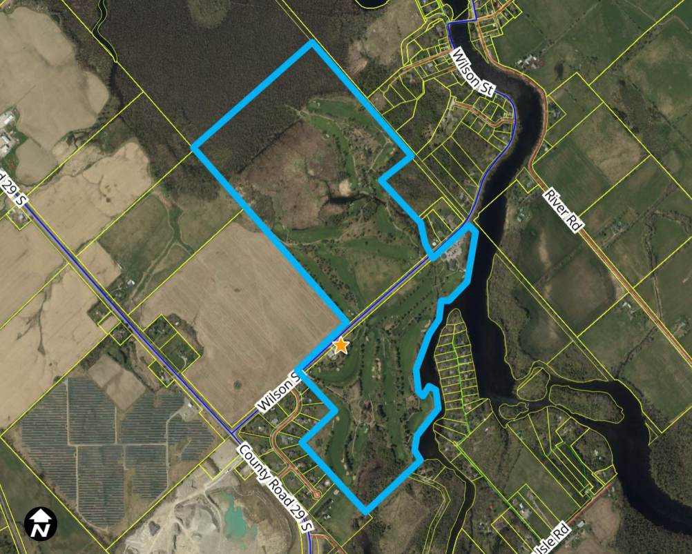 Satellite image of a rural area with a property outlined in blue.