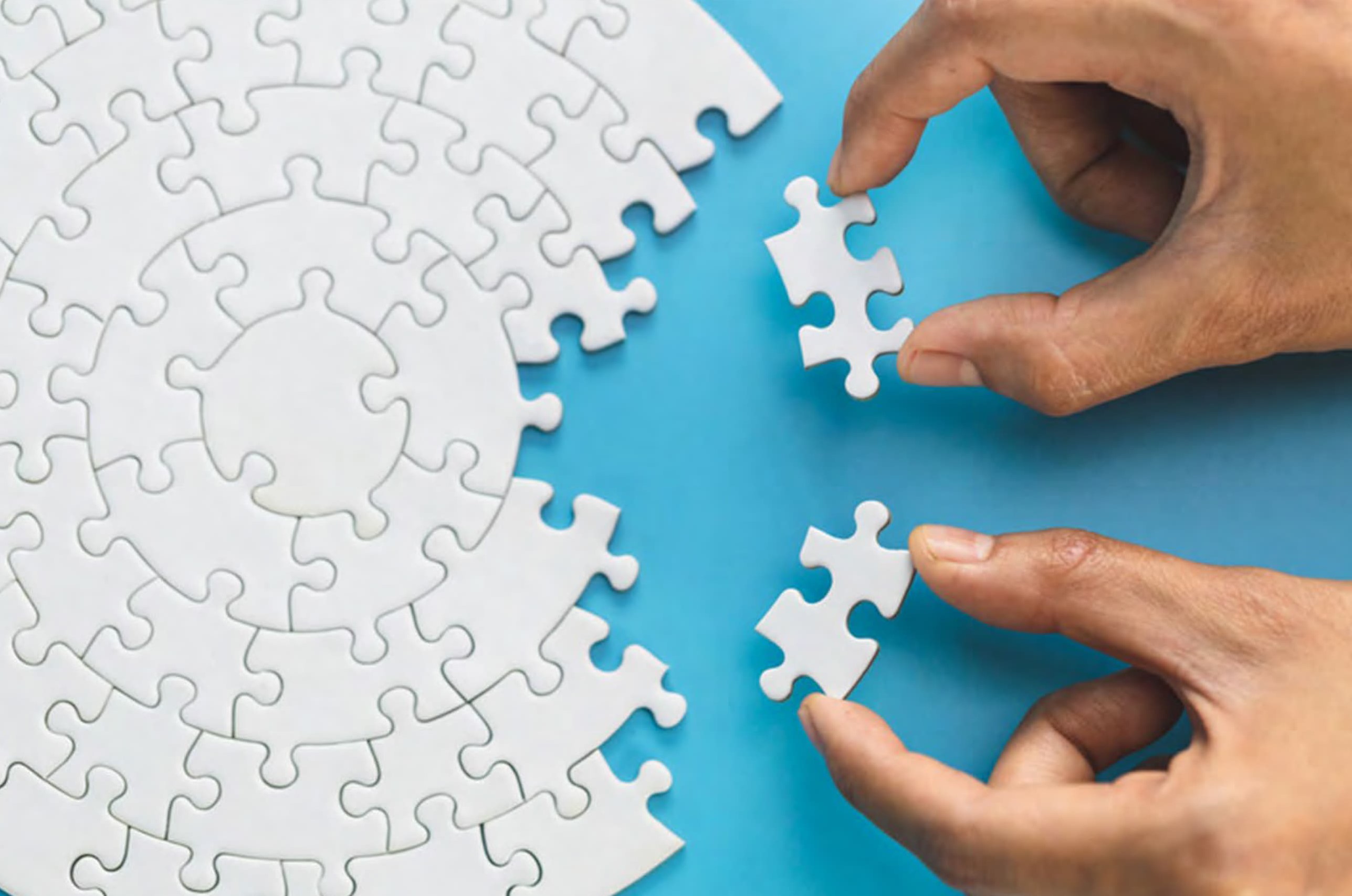 Hands putting a puzzle together