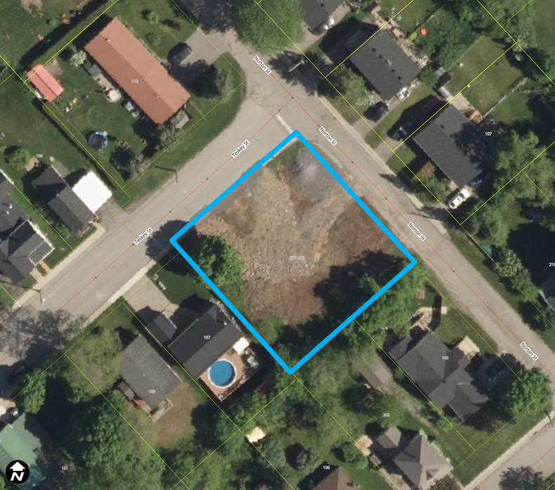 Satellite image of residential area with a property outlined in a blue box.
