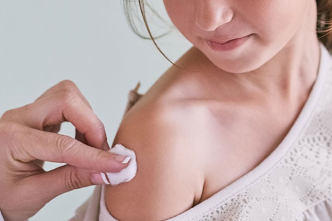 Zoomed in photo of a child getting a vaccination in the arm