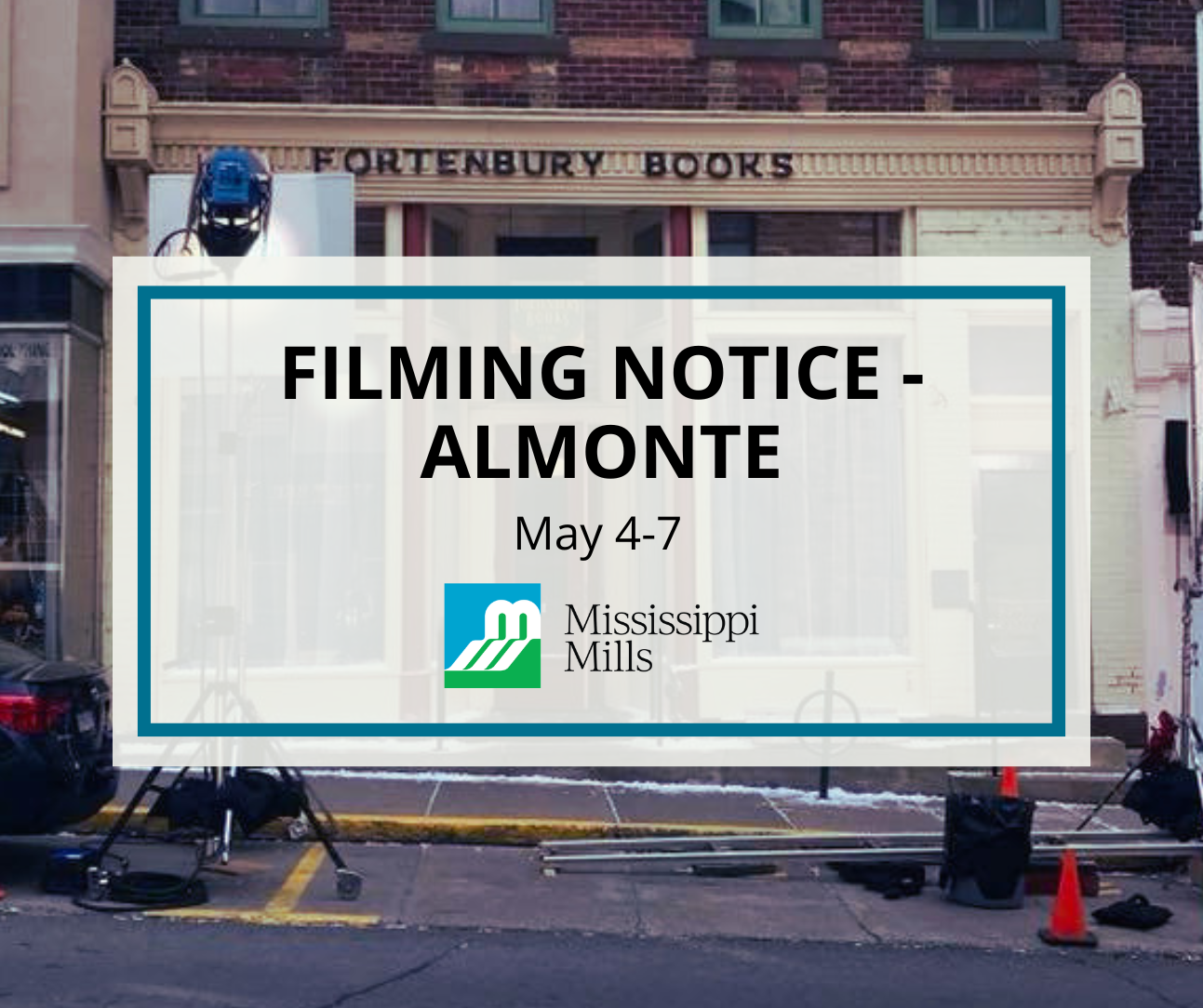 Film equipment and pylons outside of a businesses on a downtown street. A white box with blue border has black text that reads 'Filming Notice - Almonte, May 4-7.'