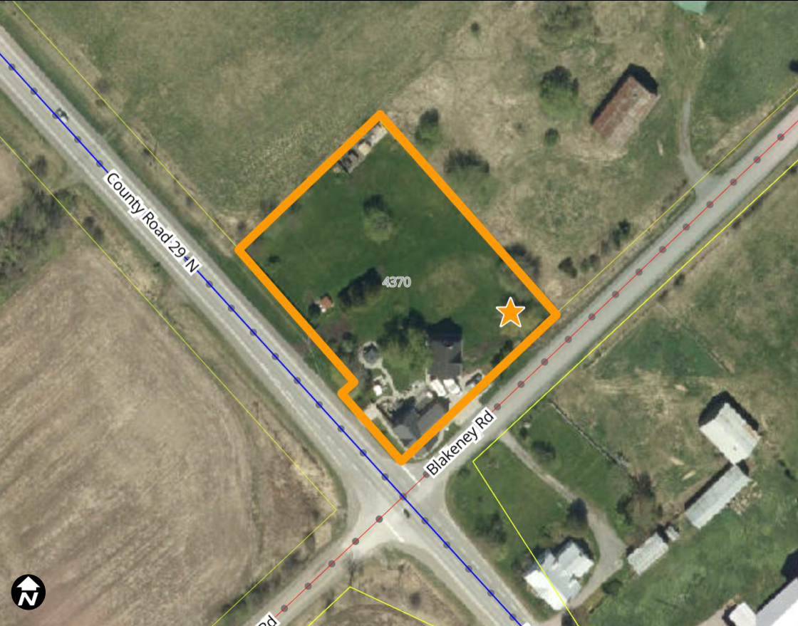 Aerial view of a rural area with a property outlined in orange