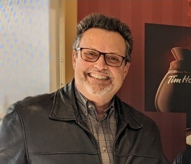 Photo of man with dark hair smiling