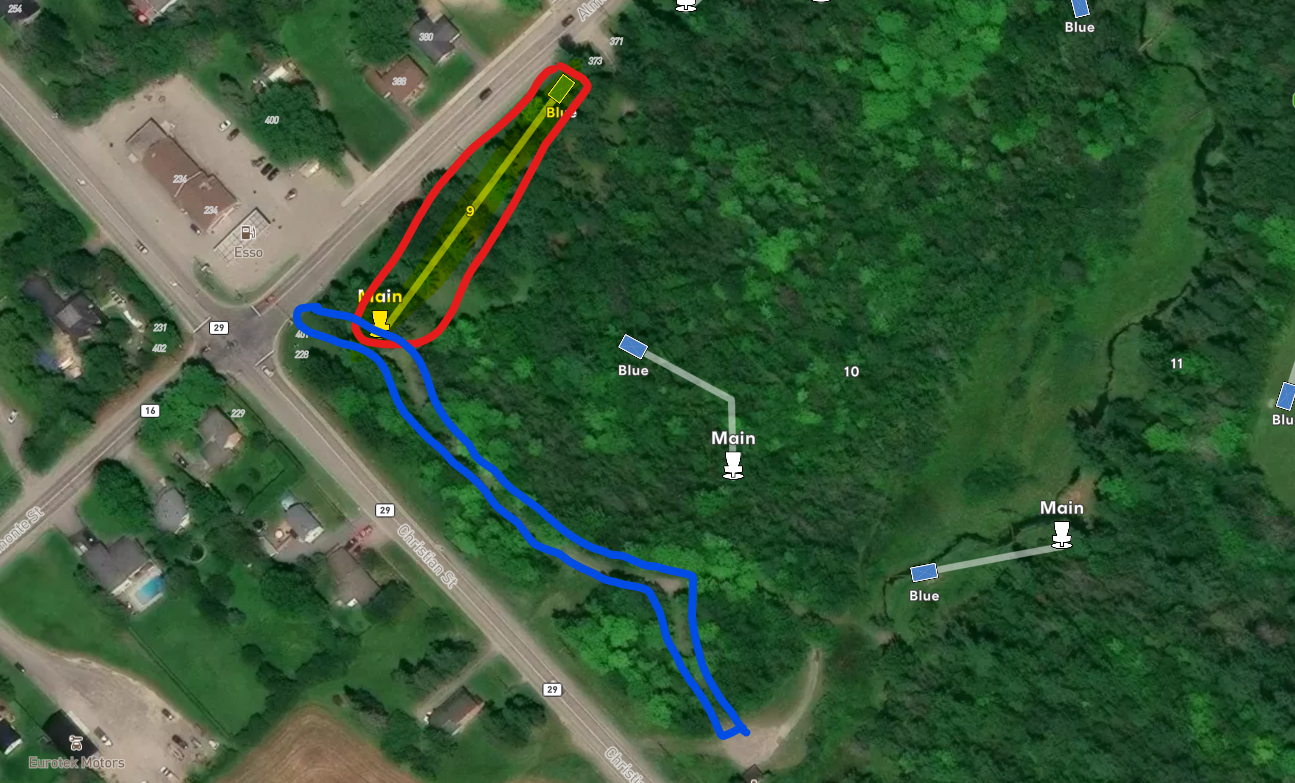 Satellite map shows green park area with lots of trees. One area is circled in red, next to a trail. Another area is circled in blue, directly in front of the red circled area.