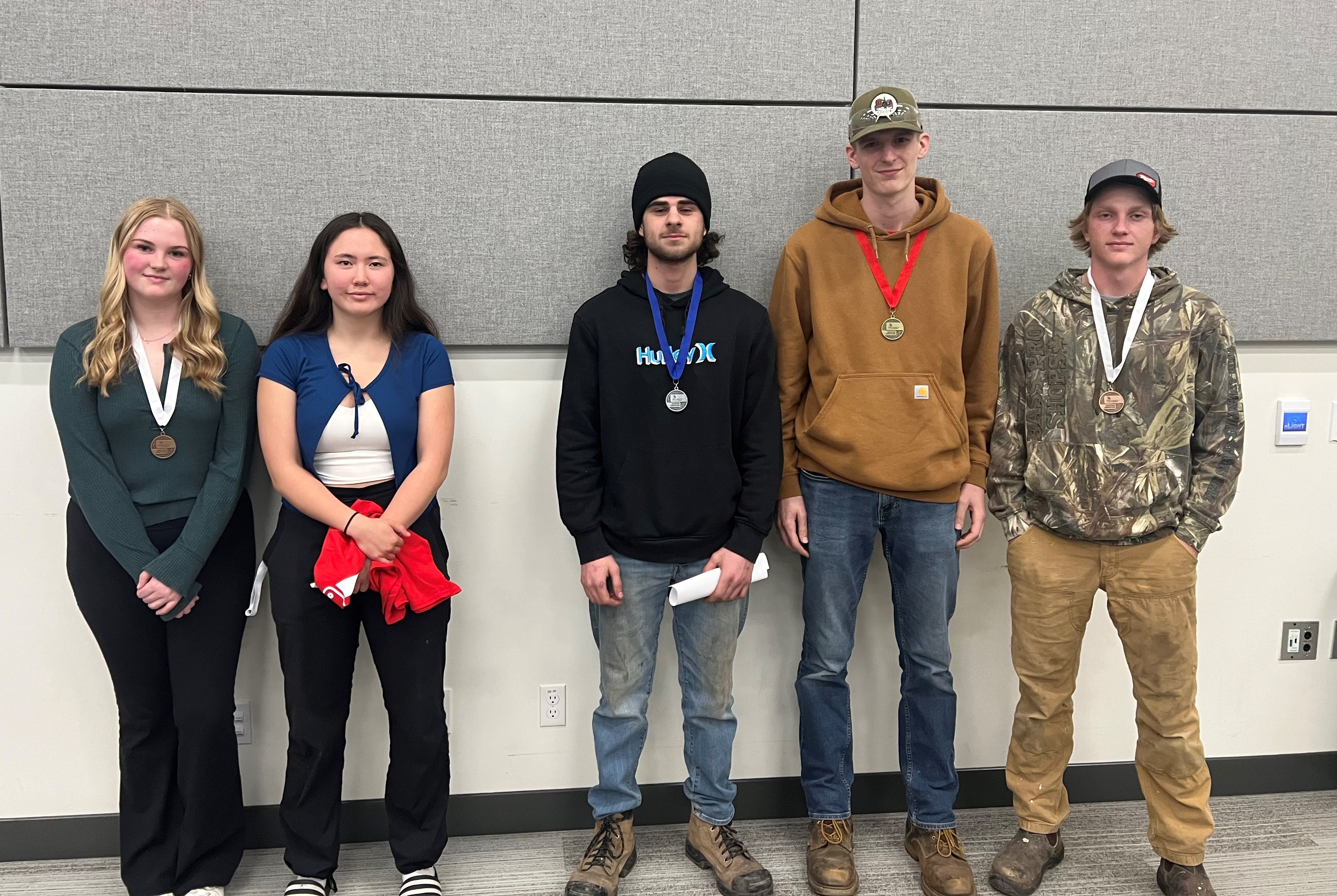 Five students stand together for a group photo
