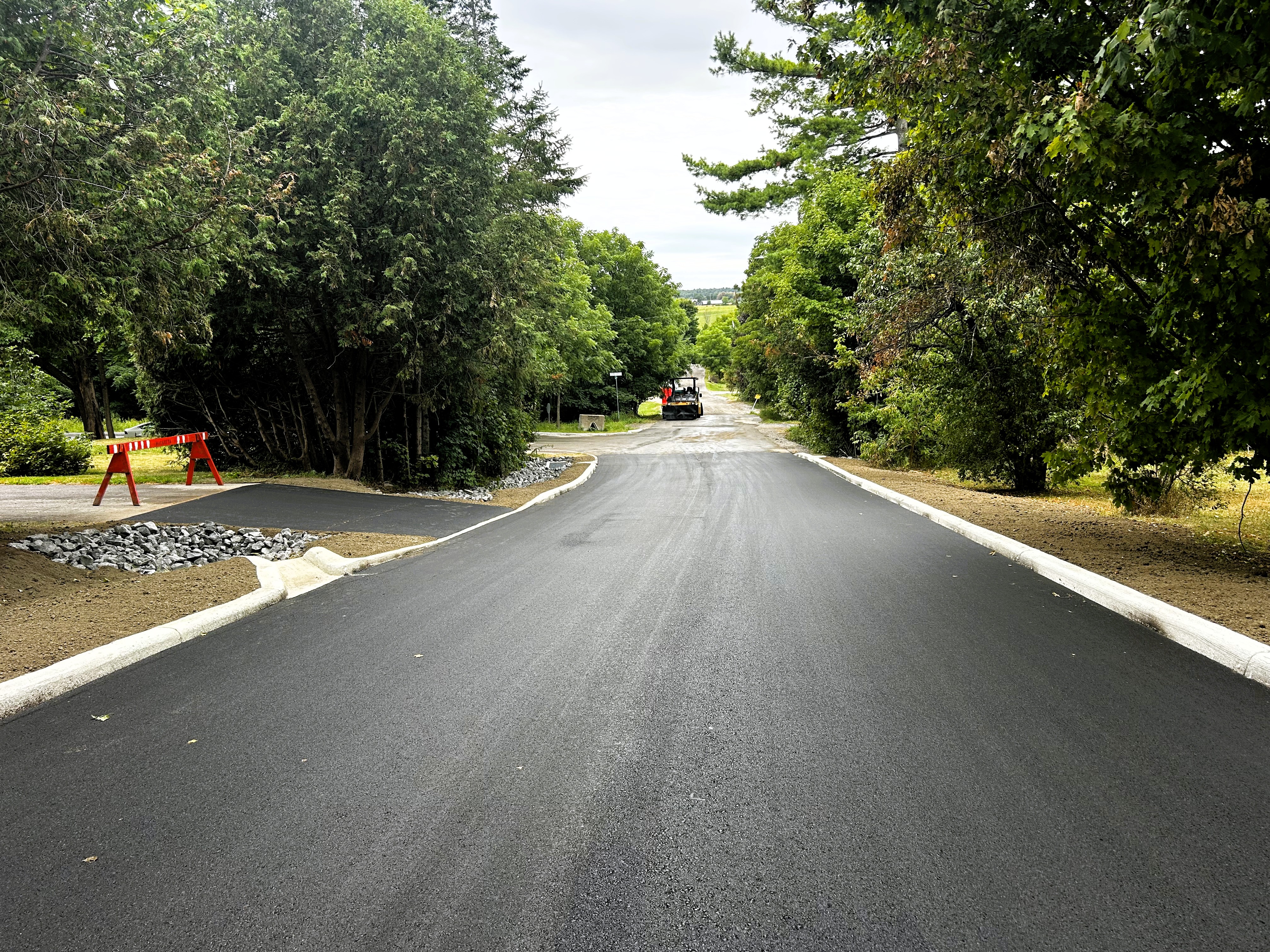 Photo of freshly paved road in neighbourhood with new curbs