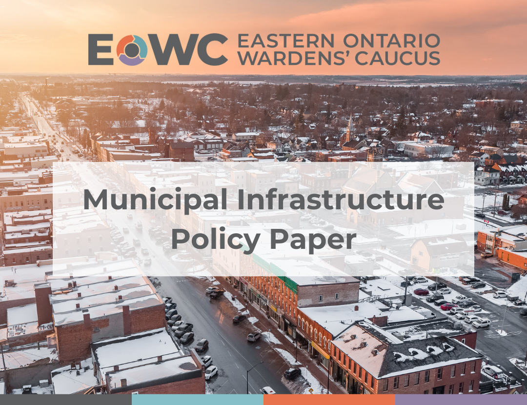 Overhead shot of a town with snow covered buildings. Text reads 'Eastern Ontario Wardens' Caucus Municipal Infrastructure Policy Paper'